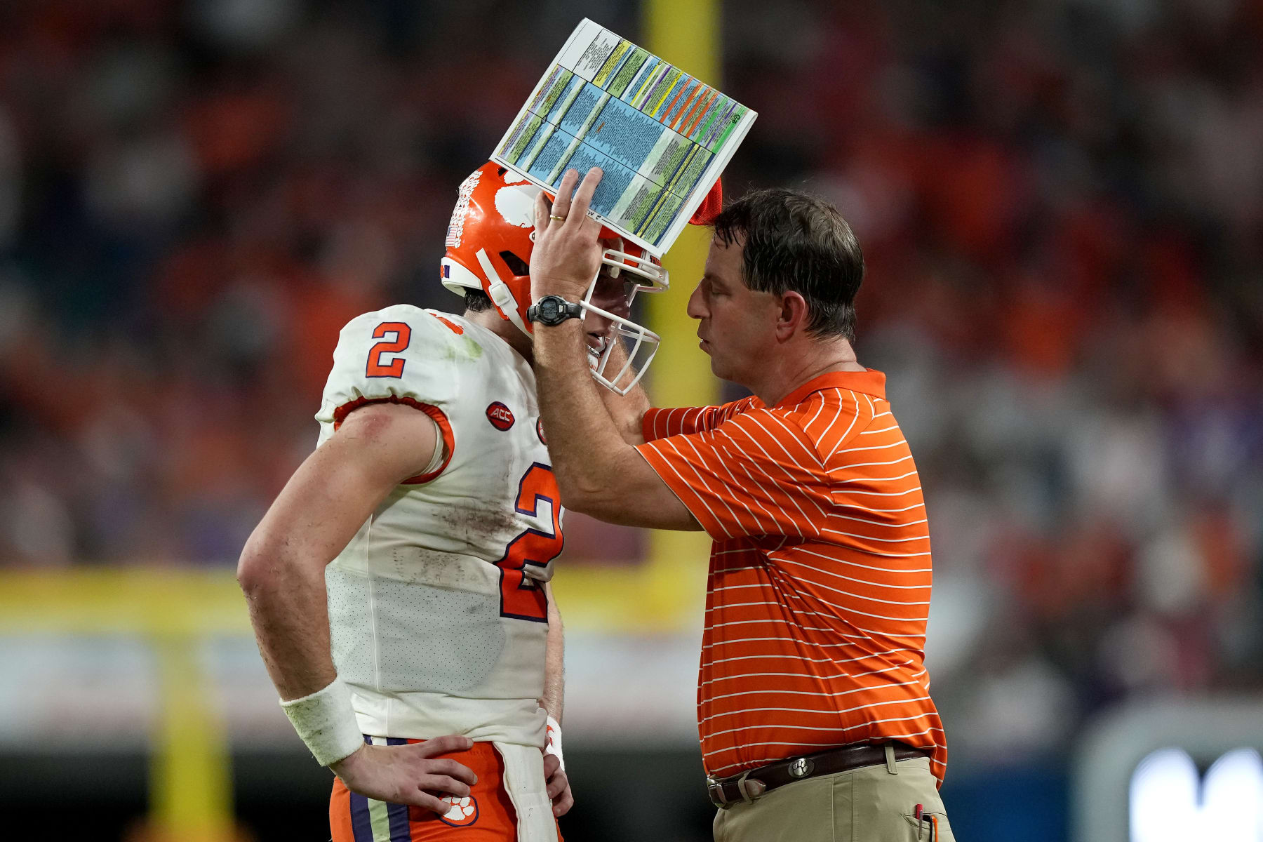MIAMI GARDENS, FLORIDA - DECEMBER 30: Head coach Dabo Swinney (R) of the Clemson Tigers talks with Cade Klubnik #2 after a play against the Tennessee Volunteers at the end of the first half of the Capital One Orange Bowl at Hard Rock Stadium on December 30, 2022 in Miami Gardens, Florida. (Photo by Eric Espada/Getty Images)