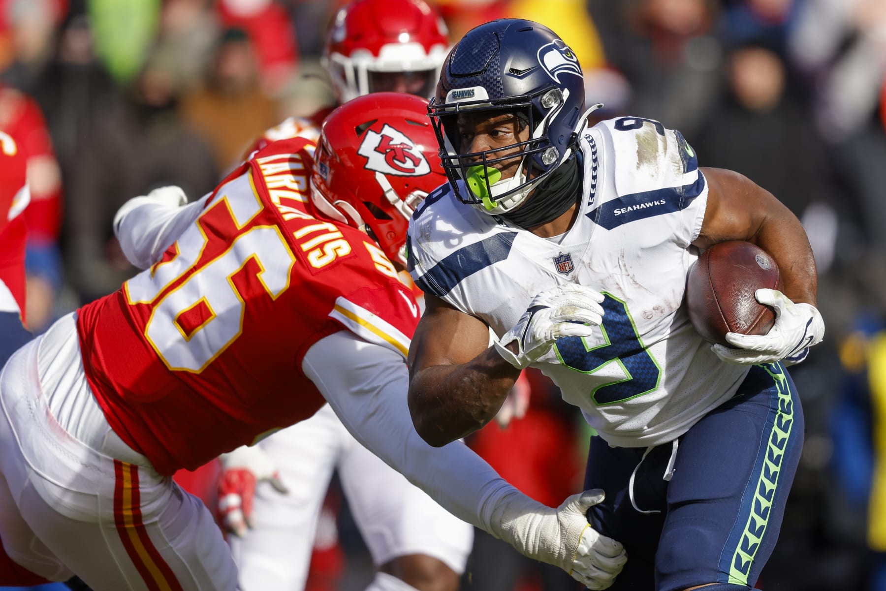 KANSAS CITY, MO - DECEMBER 24: Kenneth Walker III #9 of the Seattle Seahawks runs past George Karlaftis #56 of the Kansas City Chiefs during the second quarter at Arrowhead Stadium on December 24, 2022 in Kansas City, Missouri. (Photo by David Eulitt/Getty Images)
