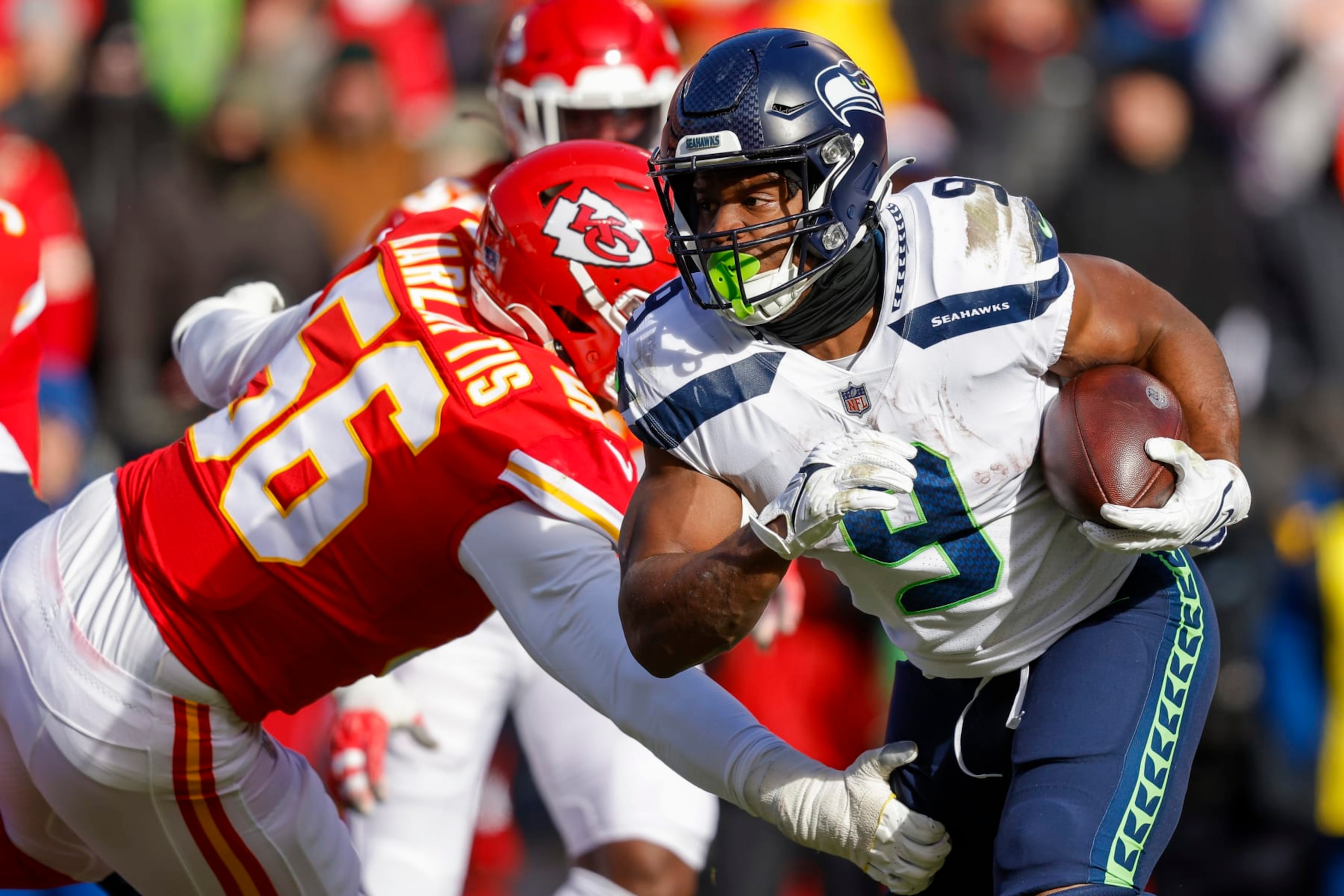 KANSAS CITY, MO - DECEMBER 24: Kenneth Walker III #9 of the Seattle Seahawks runs past George Karlaftis #56 of the Kansas City Chiefs during the second quarter at Arrowhead Stadium on December 24, 2022 in Kansas City, Missouri. (Photo by David Eulitt/Getty Images)