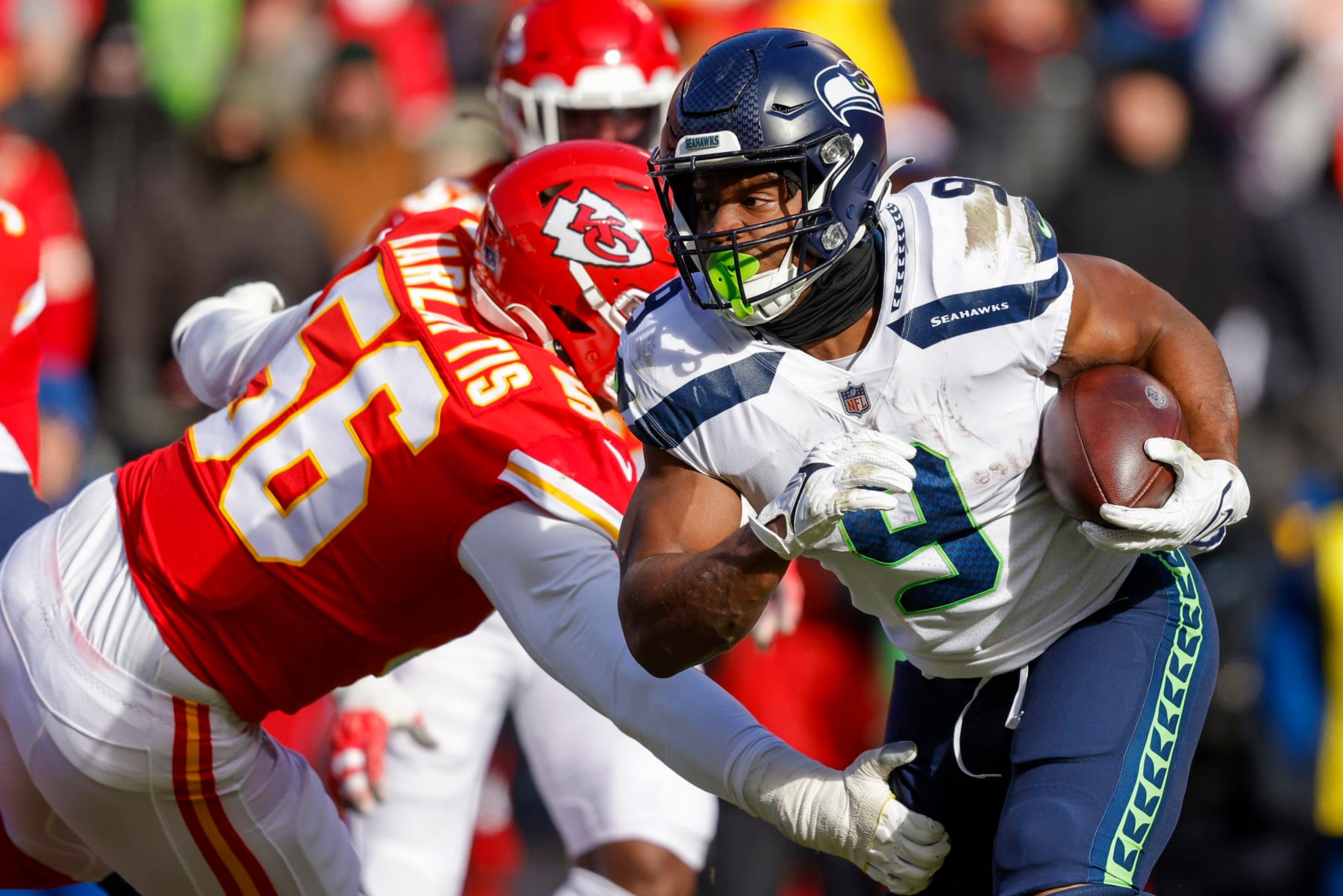 KANSAS CITY, MO - DECEMBER 24: Kenneth Walker III #9 of the Seattle Seahawks runs past George Karlaftis #56 of the Kansas City Chiefs during the second quarter at Arrowhead Stadium on December 24, 2022 in Kansas City, Missouri. (Photo by David Eulitt/Getty Images)