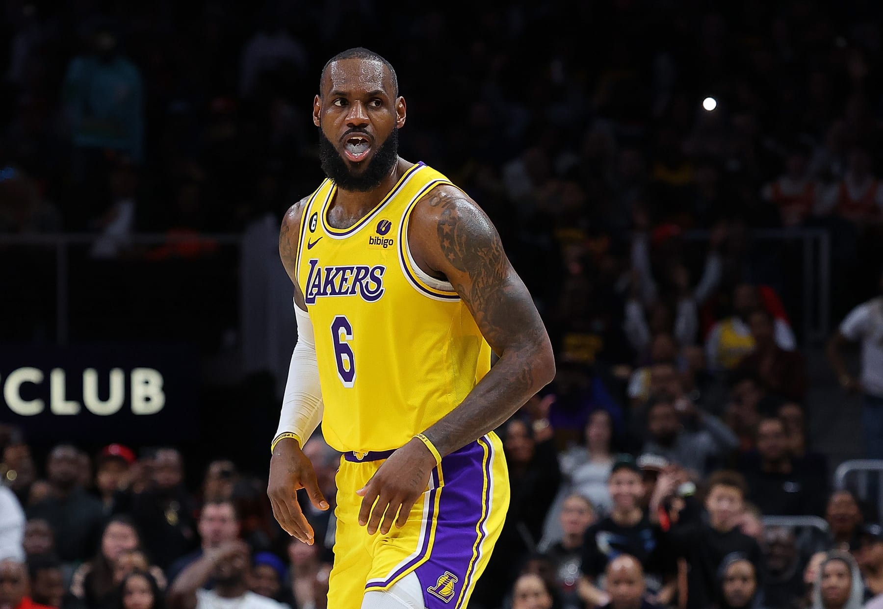 ATLANTA, GEORGIA - DECEMBER 30:  LeBron James #6 of the Los Angeles Lakers reacts after shooting a three-point basket against Onyeka Okongwu #17 of the Atlanta Hawks during the fourth quarter at State Farm Arena on December 30, 2022 in Atlanta, Georgia.  NOTE TO USER: User expressly acknowledges and agrees that, by downloading and or using this photograph, User is consenting to the terms and conditions of the Getty Images License Agreement.  (Photo by Kevin C. Cox/Getty Images)