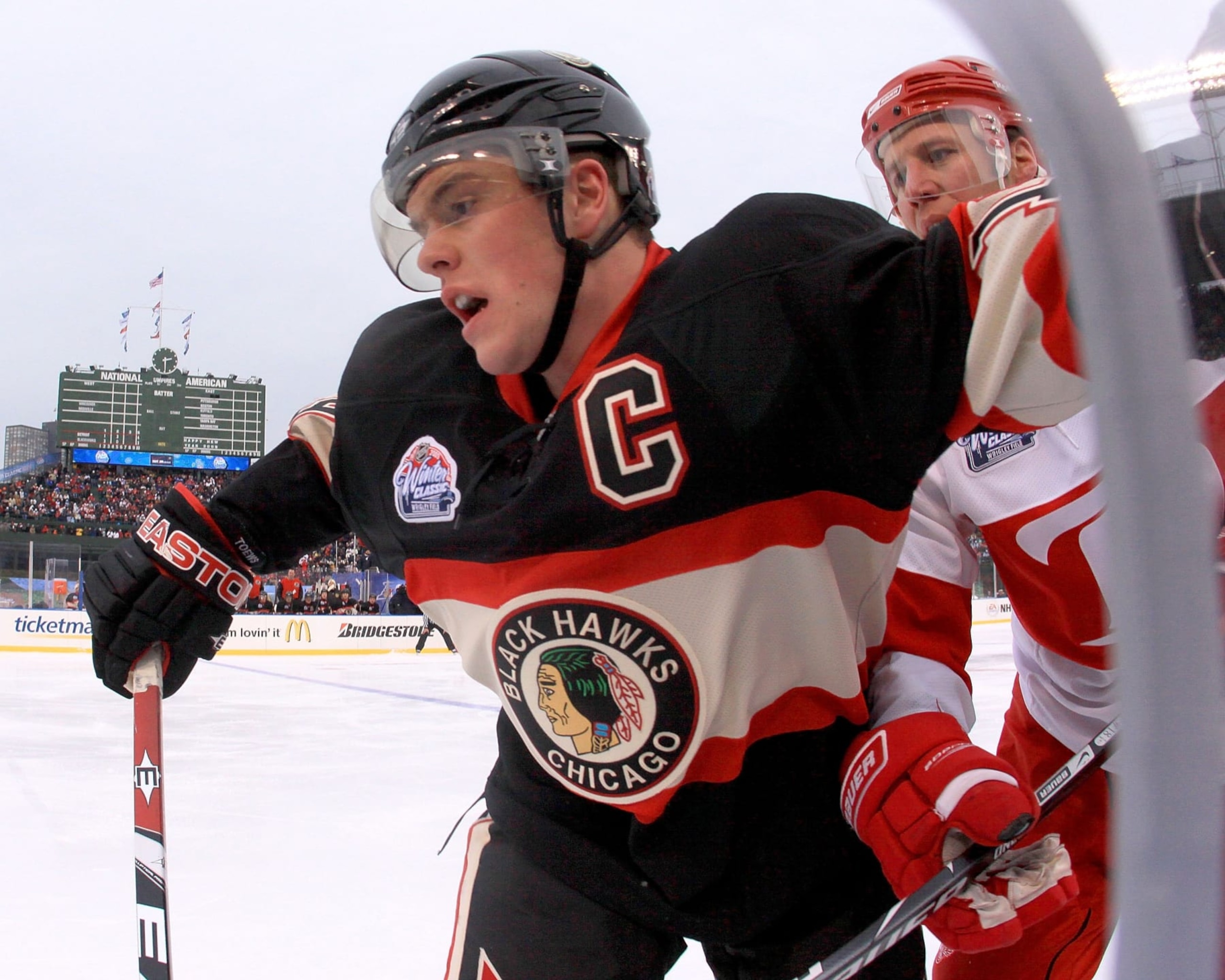 CHICAGO - JANUARY 01: Jonathan Towes #19 of the Chicago Blackhawks checks Kirk Maltby #18 of the Detroit Red Wings during a NHL game on January 1, 2009 at Wrigley Field in Chicago, Illinois. The Wings won 6-4 (Photo by Dave Reginek/NHLI via Getty Images) CHICAGO - JANUARY 01: Jonathan Towes #19 of the Chicago Blackhawks checks Kirk Maltby #18 of the Detroit Red Wings during a NHL game on January 1, 2009 at Wrigley Field in Chicago, Illinois. The Wings won 6-4 (Photo by Dave Reginek/NHLI via Getty Images)