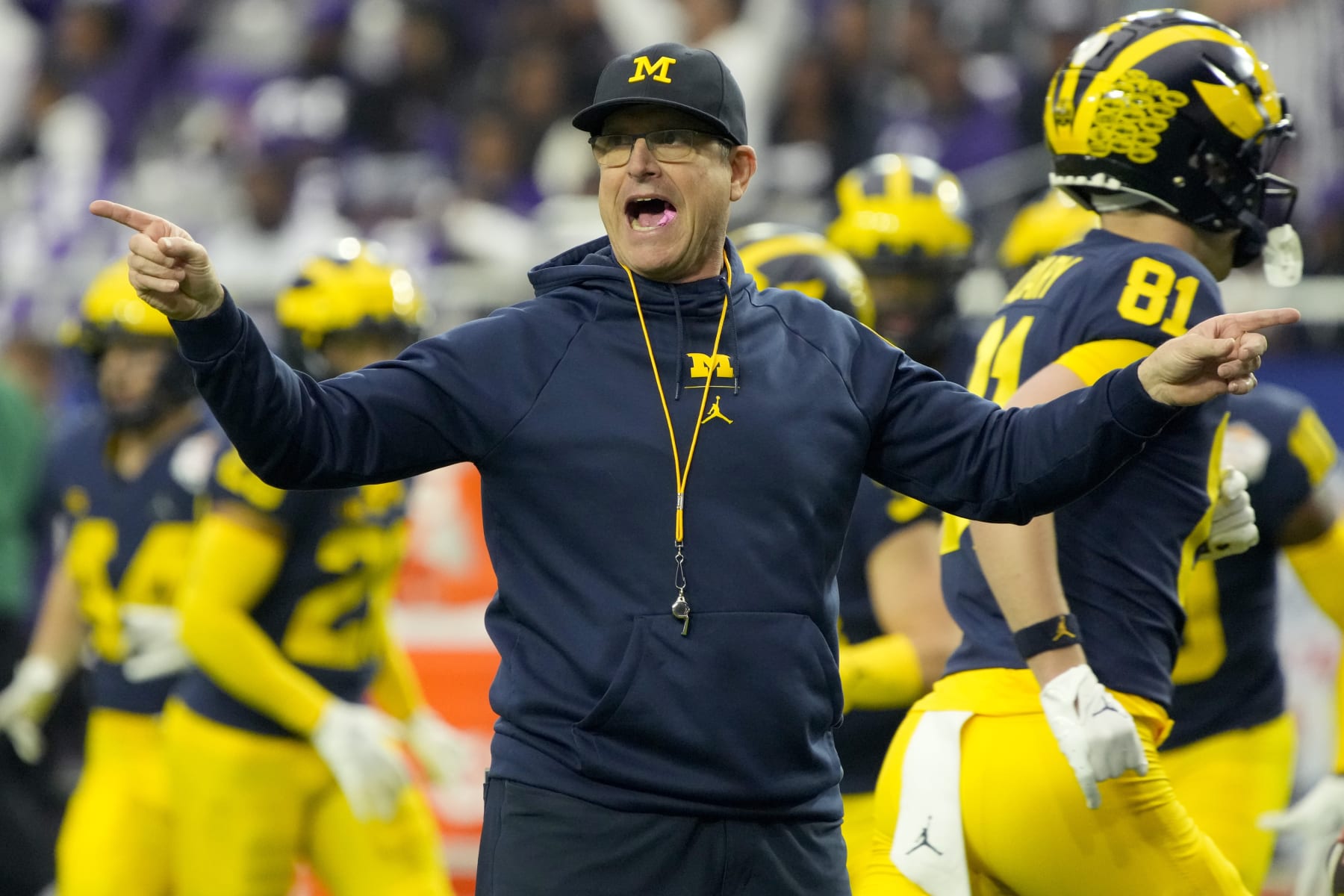 Michigan head coach Jim Harbaugh watches his players prior to the Fiesta Bowl NCAA college football semifinal playoff game against TCU, Saturday, Dec. 31, 2022, in Glendale, Ariz. (AP Photo/Rick Scuteri)