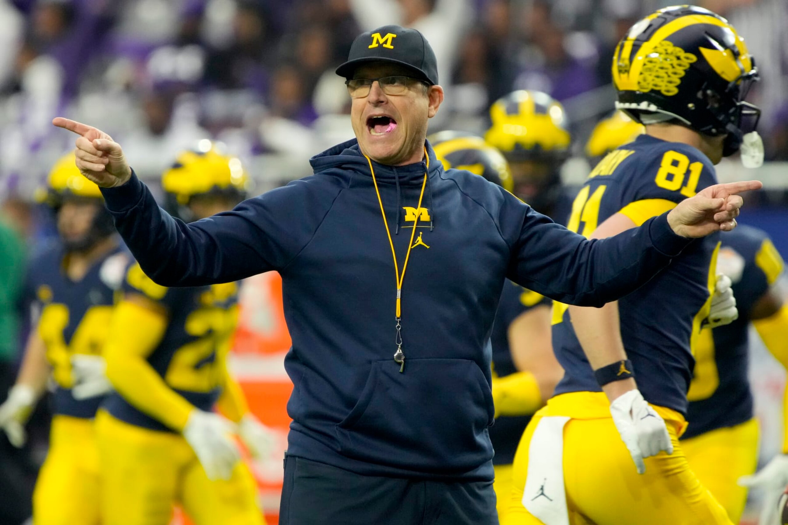 Michigan head coach Jim Harbaugh watches his players prior to the Fiesta Bowl NCAA college football semifinal playoff game against TCU, Saturday, Dec. 31, 2022, in Glendale, Ariz. (AP Photo/Rick Scuteri)