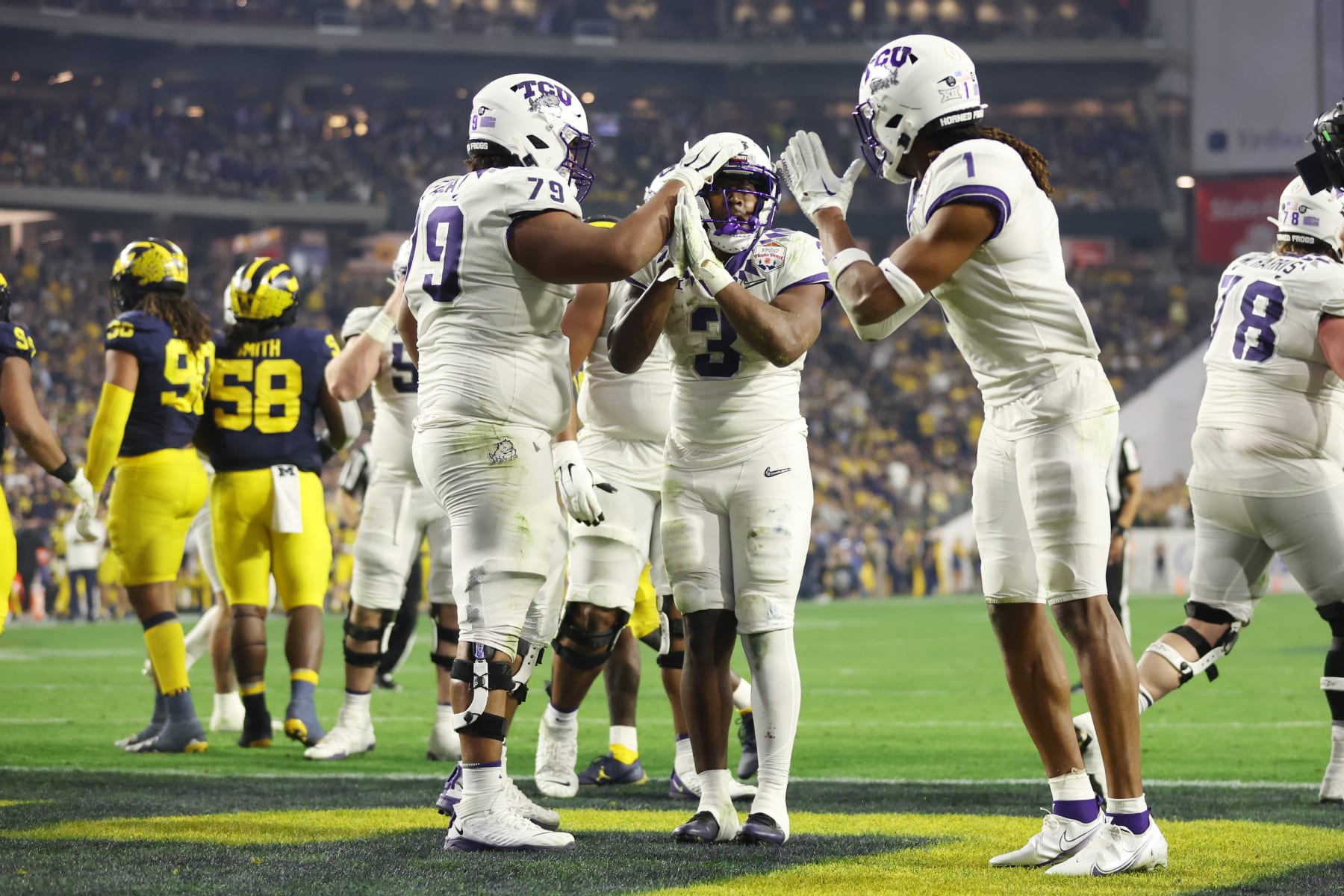 TCU's Emari Demercado celebrates with teammates after rushing for a touchdown.