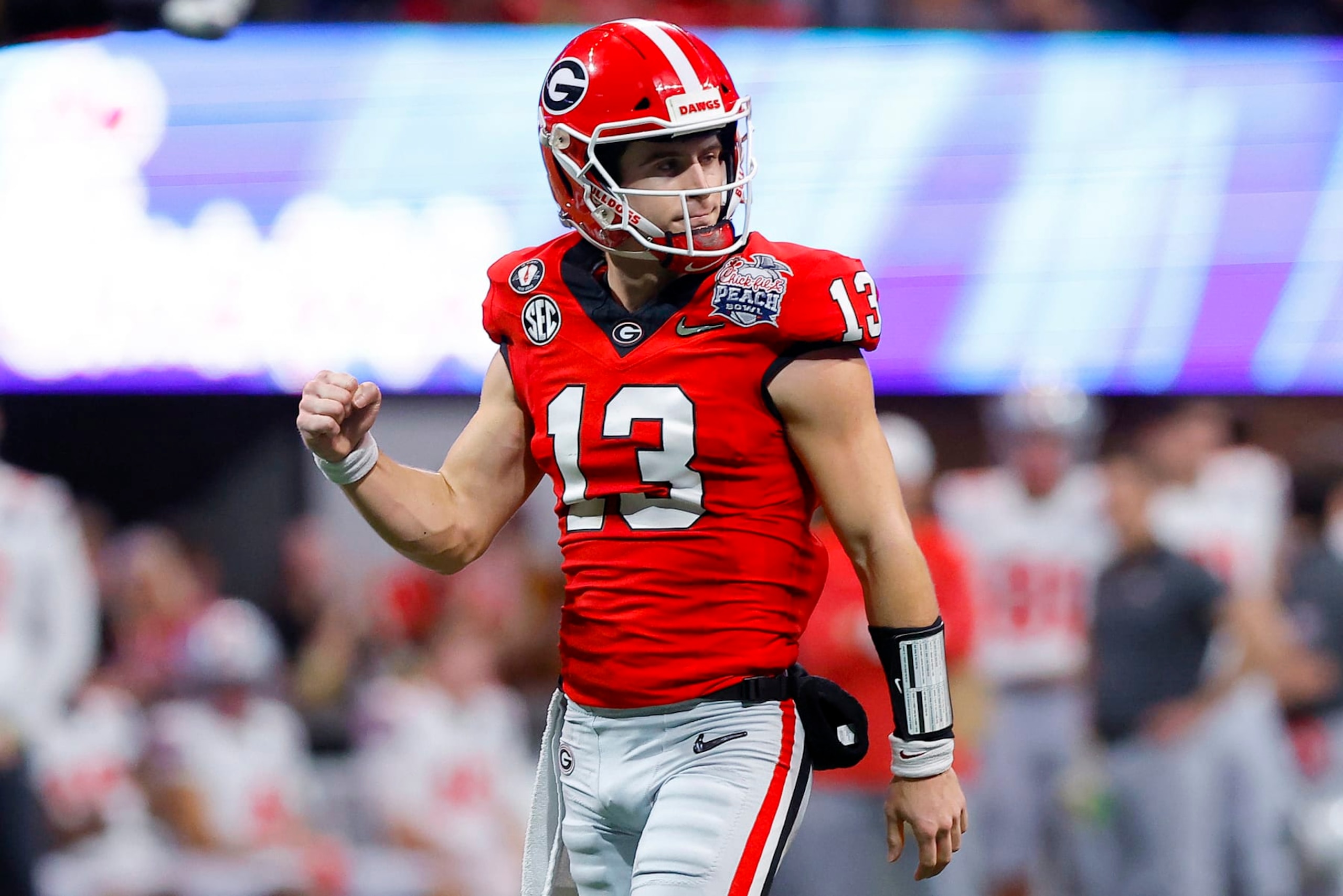 ATLANTA, GEORGIA - DECEMBER 31: Stetson Bennett #13 of the Georgia Bulldogs reacts after a touchdown during the first quarter against the Ohio State Buckeyes in the Chick-fil-A Peach Bowl at Mercedes-Benz Stadium on December 31, 2022 in Atlanta, Georgia. (Photo by Todd Kirkland/Getty Images)