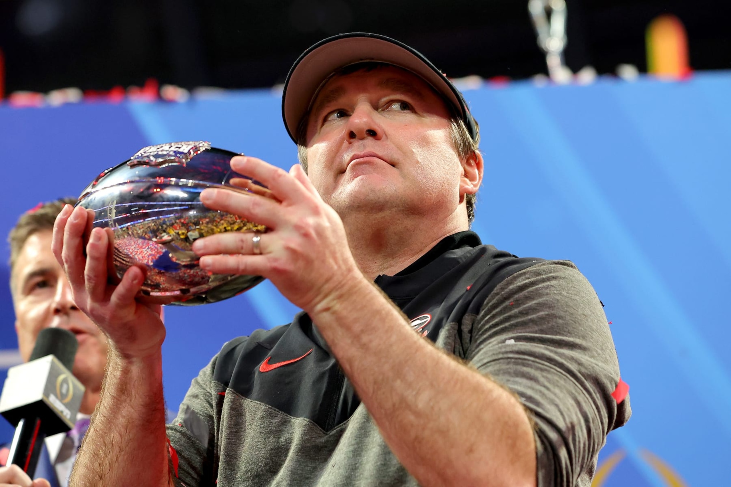 ATLANTA, GEORGIA - DECEMBER 31: Head coach Kirby Smart of the Georgia Bulldogs celebrates with the trophy after defeating the Ohio State Buckeyes in the Chick-fil-A Peach Bowl at Mercedes-Benz Stadium on December 31, 2022 in Atlanta, Georgia. (Photo by Kevin C. Cox/Getty Images) ATLANTA, GEORGIA - DECEMBER 31: Head coach Kirby Smart of the Georgia Bulldogs celebrates with the trophy after defeating the Ohio State Buckeyes in the Chick-fil-A Peach Bowl at Mercedes-Benz Stadium on December 31, 2022 in Atlanta, Georgia. (Photo by Kevin C. Cox/Getty Images)