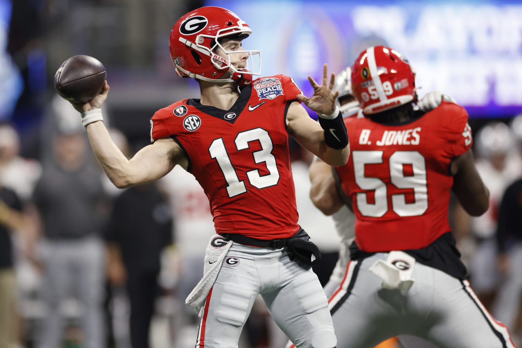 ATLANTA, GA - DECEMBER 31: Georgia Bulldogs quarterback Stetson Bennett (13) passes the ball during the Chick-fil-A Peach Bowl semifinal game against the Ohio State Buckeyes on December 31, 2022 at Mercedes-Benz Stadium in Atlanta, Georgia. (Photo by Joe Robbins/Icon Sportswire via Getty Images)