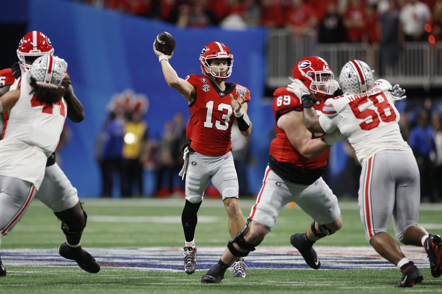 ATLANTA, GA - DECEMBER 31: Georgia Bulldogs quarterback Stetson Bennett (13) passes the ball during the Chick-fil-A Peach Bowl semifinal game against the Ohio State Buckeyes on December 31, 2022 at Mercedes-Benz Stadium in Atlanta, Georgia. (Photo by Joe Robbins/Icon Sportswire via Getty Images)