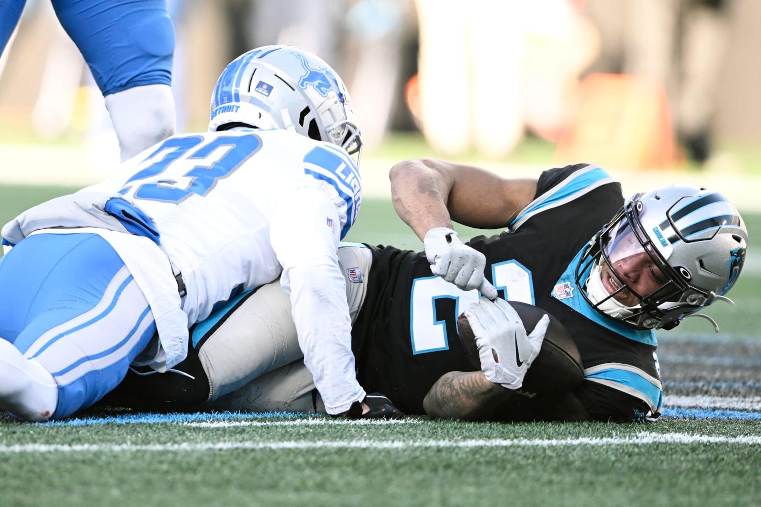 CHARLOTTE, NORTH CAROLINA - DECEMBER 24: DJ Moore #2 of the Carolina Panthers gets tackled by Mike Hughes #23 of the Detroit Lions in the third quarter at Bank of America Stadium on December 24, 2022 in Charlotte, North Carolina. (Photo by Eakin Howard/Getty Images)