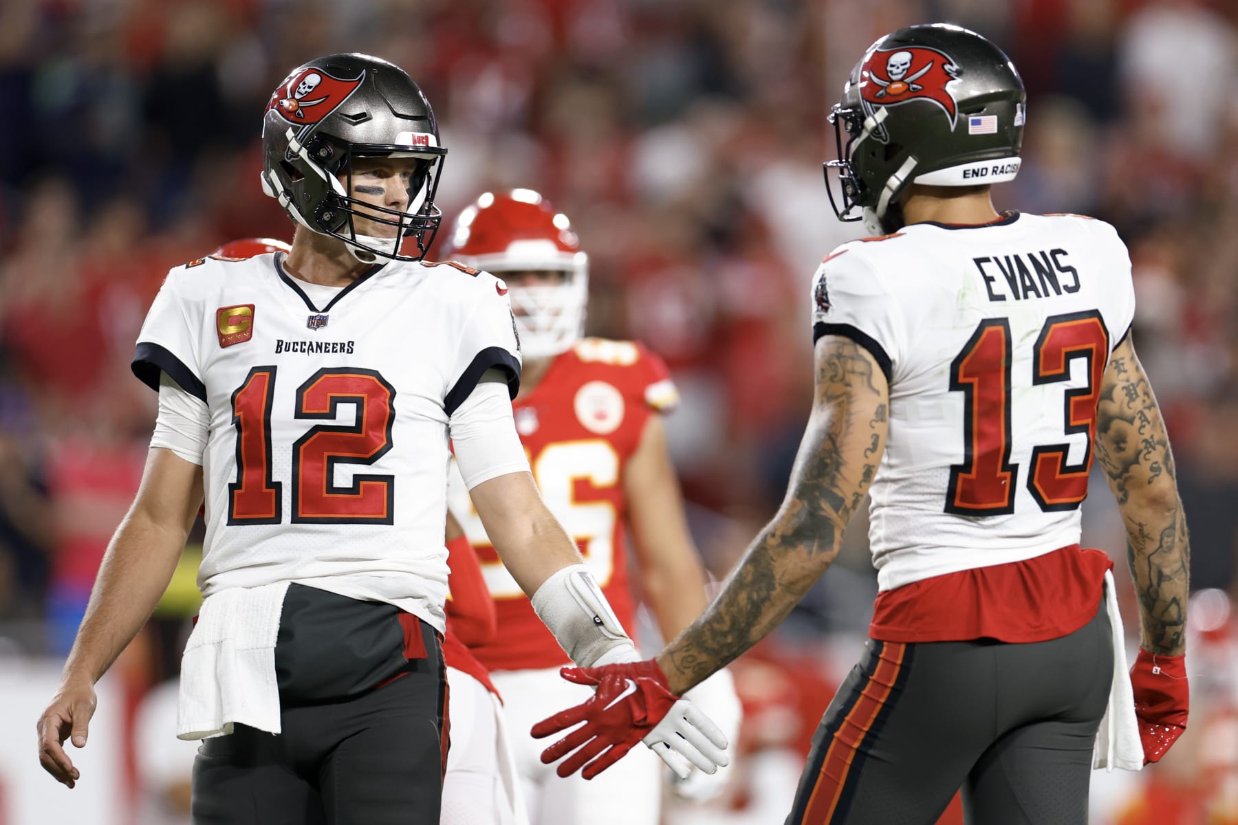 TAMPA, FLORIDA - OCTOBER 02: Tom Brady #12 and Mike Evans #13 of the Tampa Bay Buccaneers shake hands against the Kansas City Chiefs during the second quarter at Raymond James Stadium on October 02, 2022 in Tampa, Florida. (Photo by Douglas P. DeFelice/Getty Images)