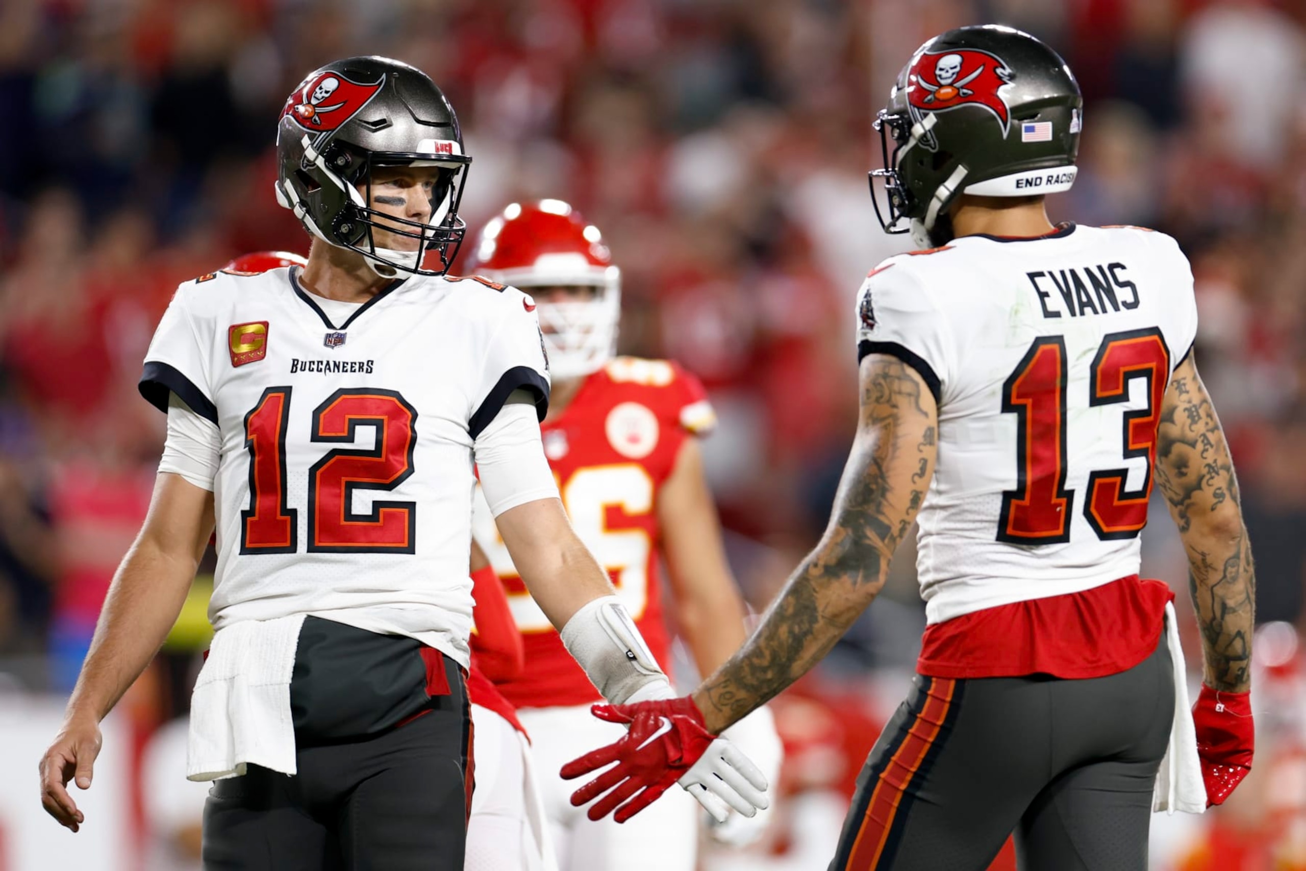 TAMPA, FLORIDA - OCTOBER 02: Tom Brady #12 and Mike Evans #13 of the Tampa Bay Buccaneers shake hands against the Kansas City Chiefs during the second quarter at Raymond James Stadium on October 02, 2022 in Tampa, Florida. (Photo by Douglas P. DeFelice/Getty Images)