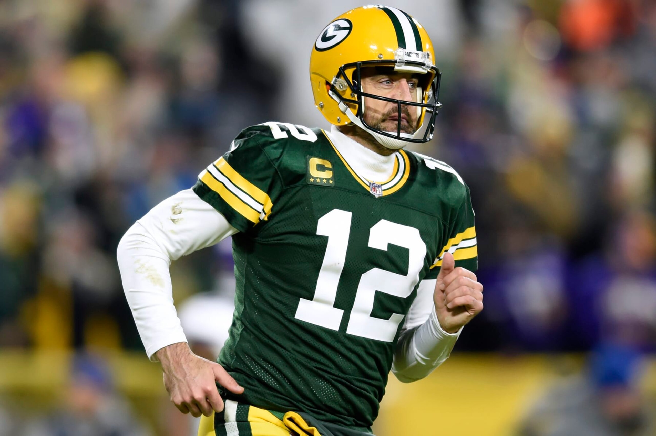 GREEN BAY, WISCONSIN - JANUARY 01: Aaron Rodgers #12 of the Green Bay Packers reacts after throwing a touchdown pass during the second quarter against the Minnesota Vikings at Lambeau Field on January 01, 2023 in Green Bay, Wisconsin. (Photo by Kayla Wolf/Getty Images)