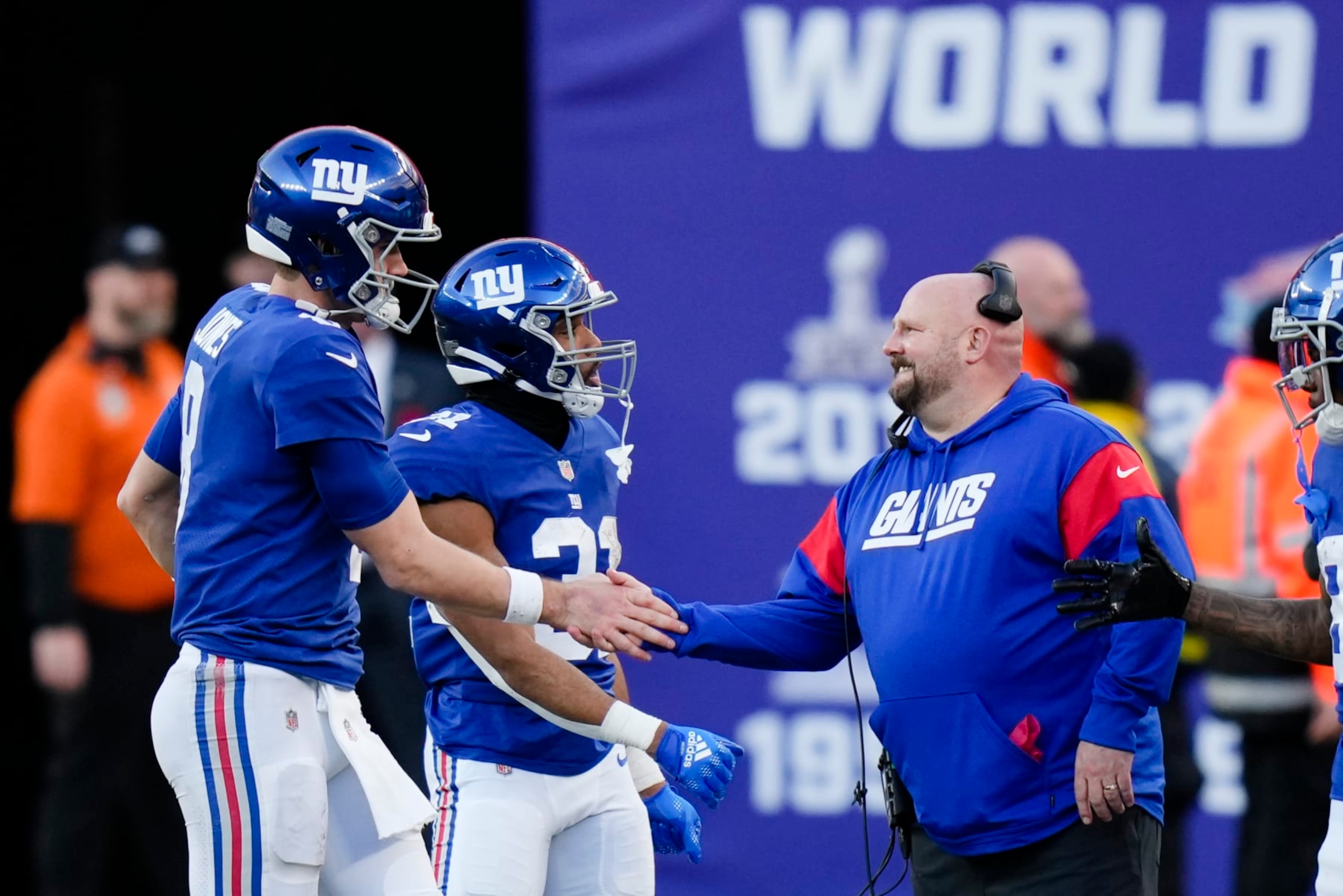 New York Giants quarterback Daniel Jones, left, is greeted by head coach Brian Daboll while leaving during the second half of an NFL football game against the Indianapolis Colts, Sunday, Jan. 1, 2023, in East Rutherford, N.J. (AP Photo/Seth Wenig)