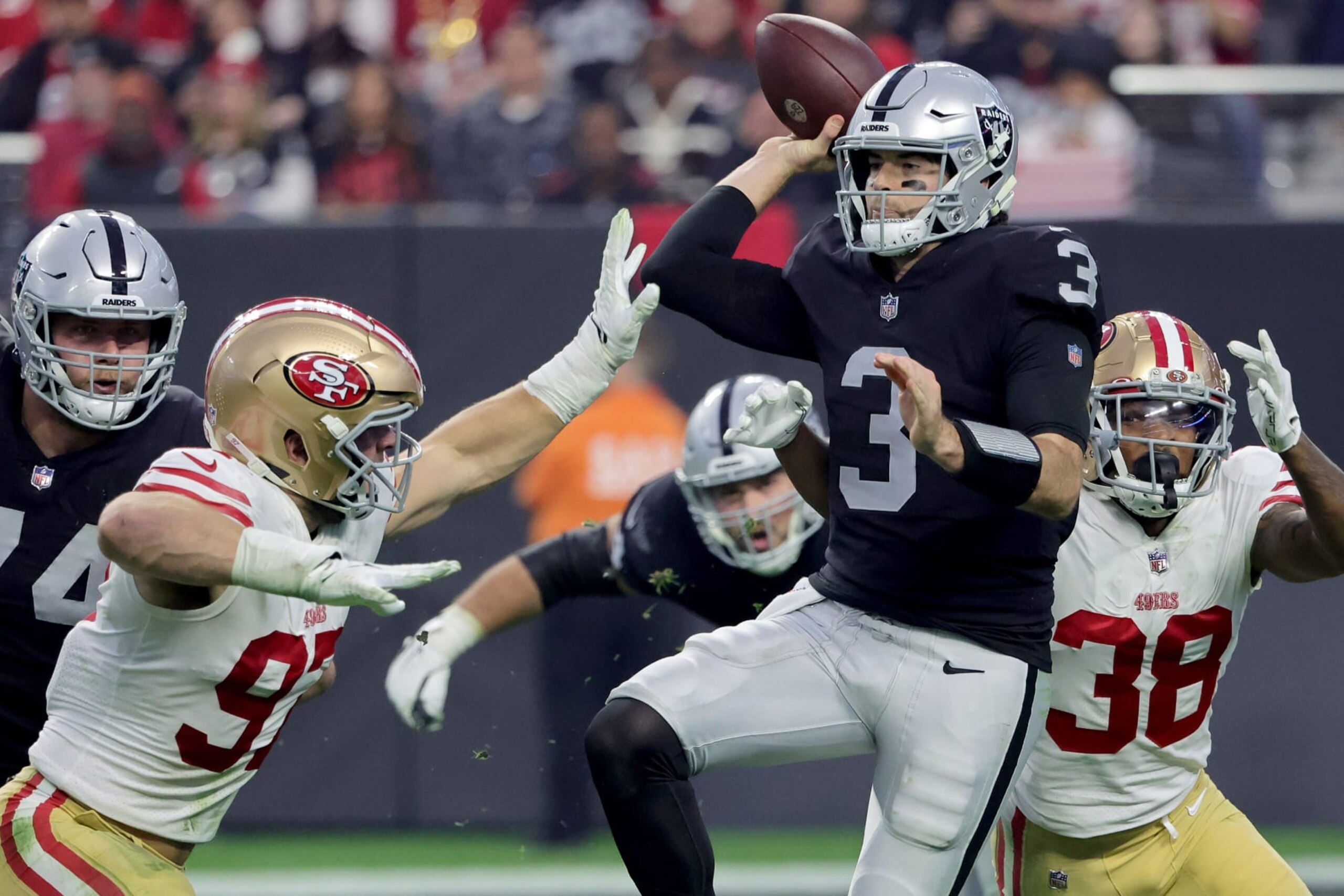 LAS VEGAS, NEVADA - JANUARY 01: Jarrett Stidham #3 of the Las Vegas Raiders is pressured by Nick Bosa #97 of the San Francisco 49ers and Deommodore Lenoir #38 of the San Francisco 49ers during the third quarter at Allegiant Stadium on January 01, 2023 in Las Vegas, Nevada. (Photo by Ethan Miller/Getty Images)