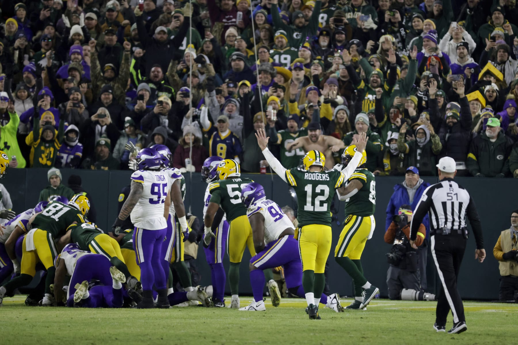 Green Bay Packers quarterback Aaron Rodgers (12) celebrates after a touchdown run by teammate AJ Dillon during the second half of an NFL football game against the Minnesota Vikings, Sunday, Jan. 1, 2023, in Green Bay, Wis. (AP Photo/Mike Roemer)
