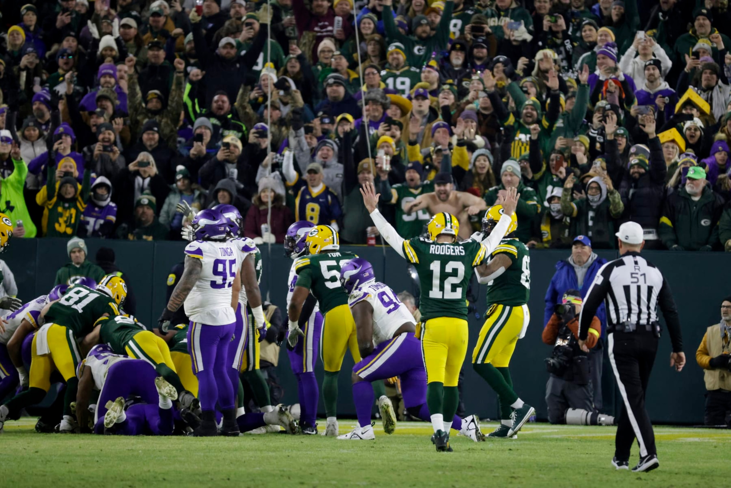 Green Bay Packers quarterback Aaron Rodgers (12) celebrates after a touchdown run by teammate AJ Dillon during the second half of an NFL football game against the Minnesota Vikings, Sunday, Jan. 1, 2023, in Green Bay, Wis. (AP Photo/Mike Roemer) Green Bay Packers quarterback Aaron Rodgers (12) celebrates after a touchdown run by teammate AJ Dillon during the second half of an NFL football game against the Minnesota Vikings, Sunday, Jan. 1, 2023, in Green Bay, Wis. (AP Photo/Mike Roemer)