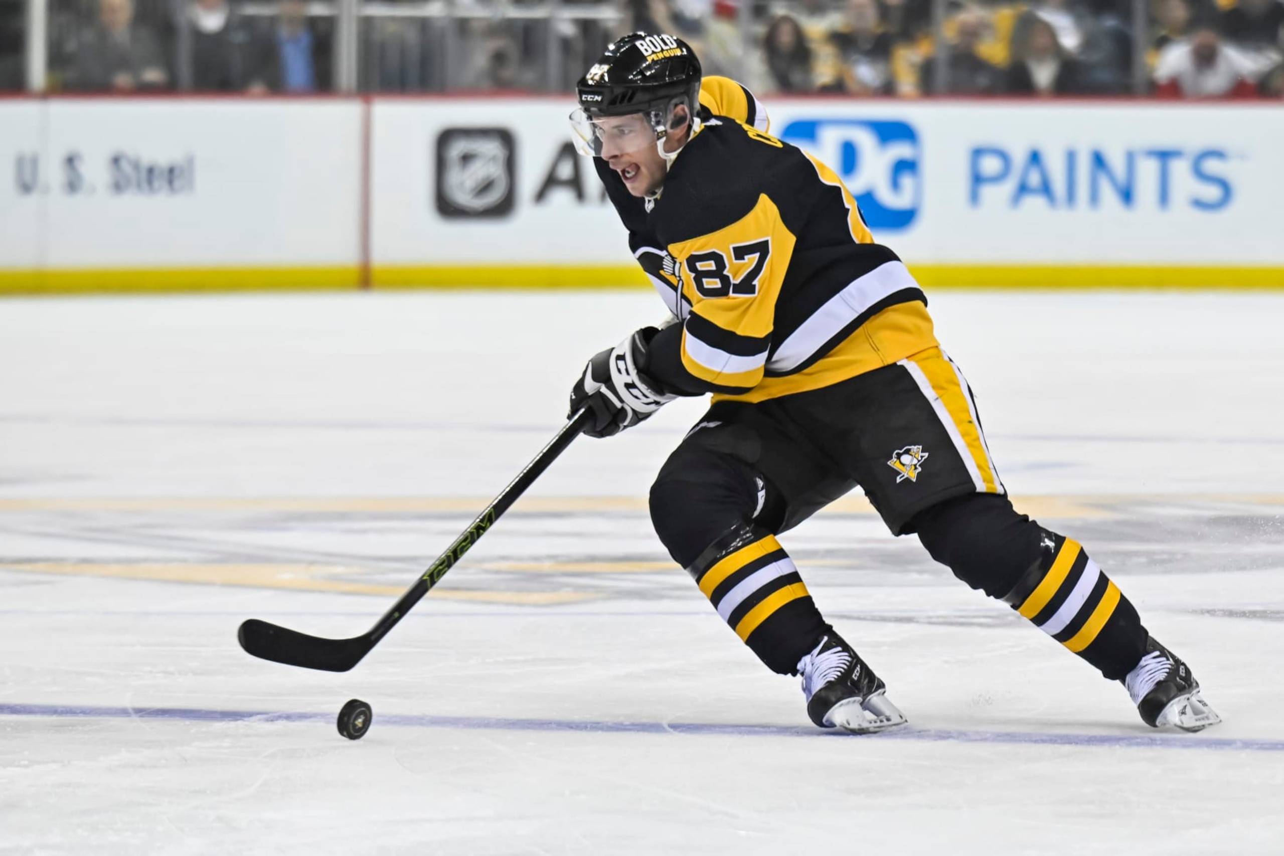 PITTSBURGH, PA - DECEMBER 28: Pittsburgh Penguins Center Sidney Crosby (87) skates with the puck during the first period in the NHL game between the Pittsburgh Penguins and the Detroit Red Wings on December 28, 2022, at PPG Paints Arena in Pittsburgh, PA. (Photo by Jeanine Leech/Icon Sportswire via Getty Images)