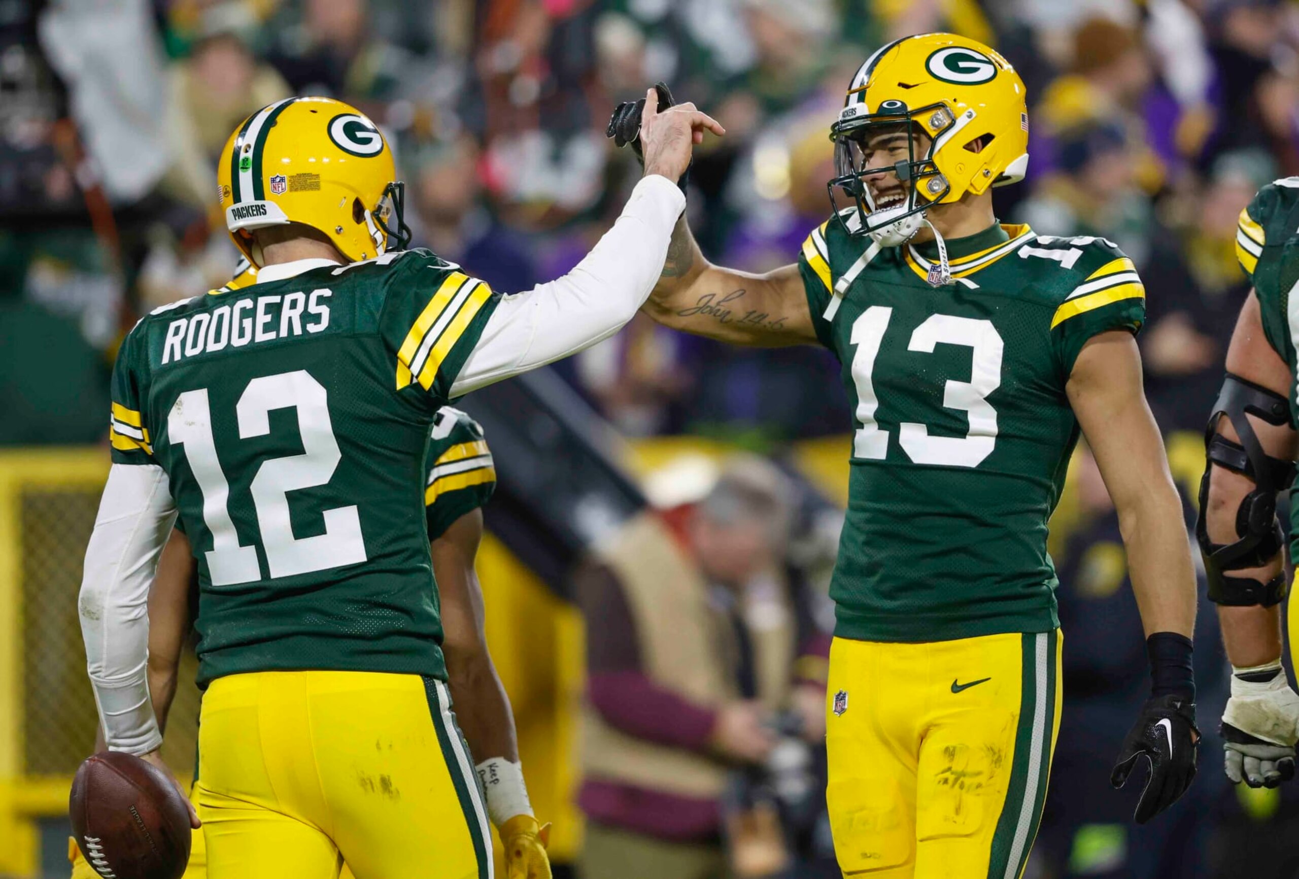 Green Bay Packers quarterback Aaron Rodgers (12) reacts with Green Bay Packers wide receiver Allen Lazard (13) after Rodgers ran in for a touchdown against the Minnesota Vikings during an NFL football game Sunday, Jan. 1, 2023, in Green Bay, Wis. (AP Photo/Jeffrey Phelps) Green Bay Packers quarterback Aaron Rodgers (12) reacts with Green Bay Packers wide receiver Allen Lazard (13) after Rodgers ran in for a touchdown against the Minnesota Vikings during an NFL football game Sunday, Jan. 1, 2023, in Green Bay, Wis. (AP Photo/Jeffrey Phelps)