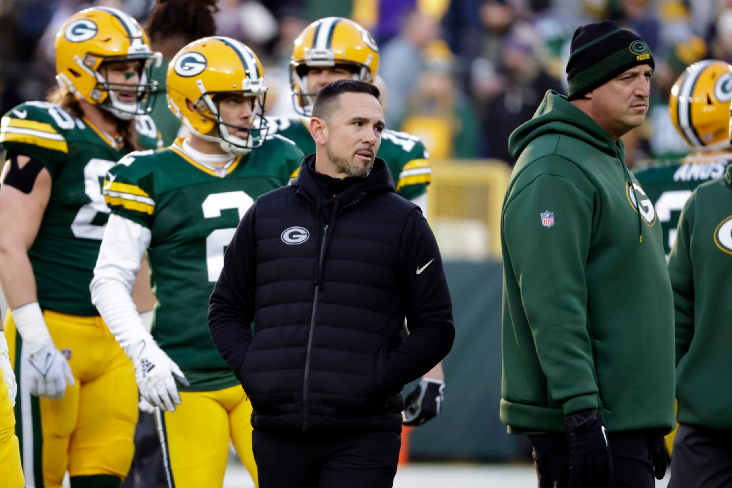 Green Bay Packers head coach Matt LaFleur, center, watches his team warmup before an NFL football game against the Minnesota Vikings, Sunday, Jan. 1, 2023, in Green Bay, Wis. (AP Photo/Mike Roemer)
