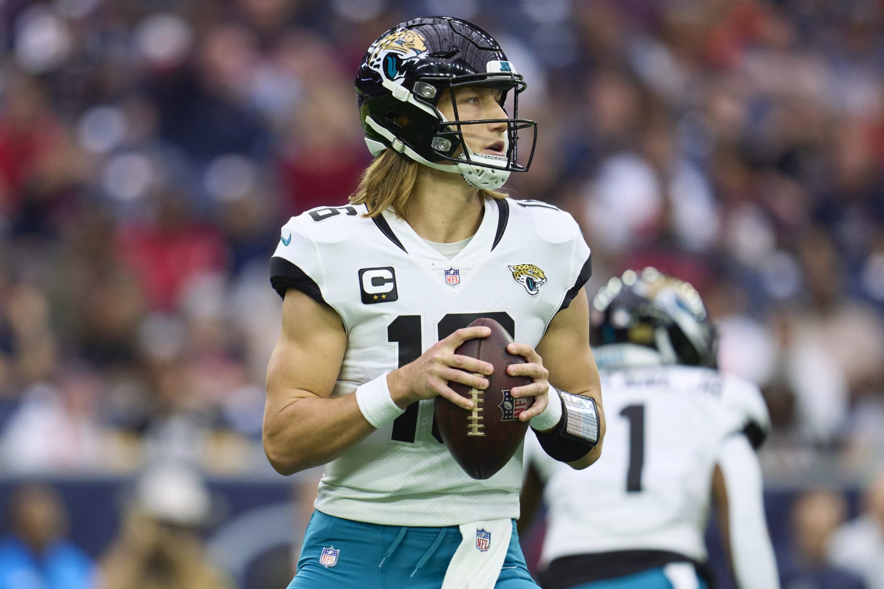 HOUSTON, TX - JANUARY 01: Trevor Lawrence #16 of the Jacksonville Jaguars drops back to pass against the Houston Texans during the first half at NRG Stadium on January 1, 2023 in Houston, Texas. (Photo by Cooper Neill/Getty Images)