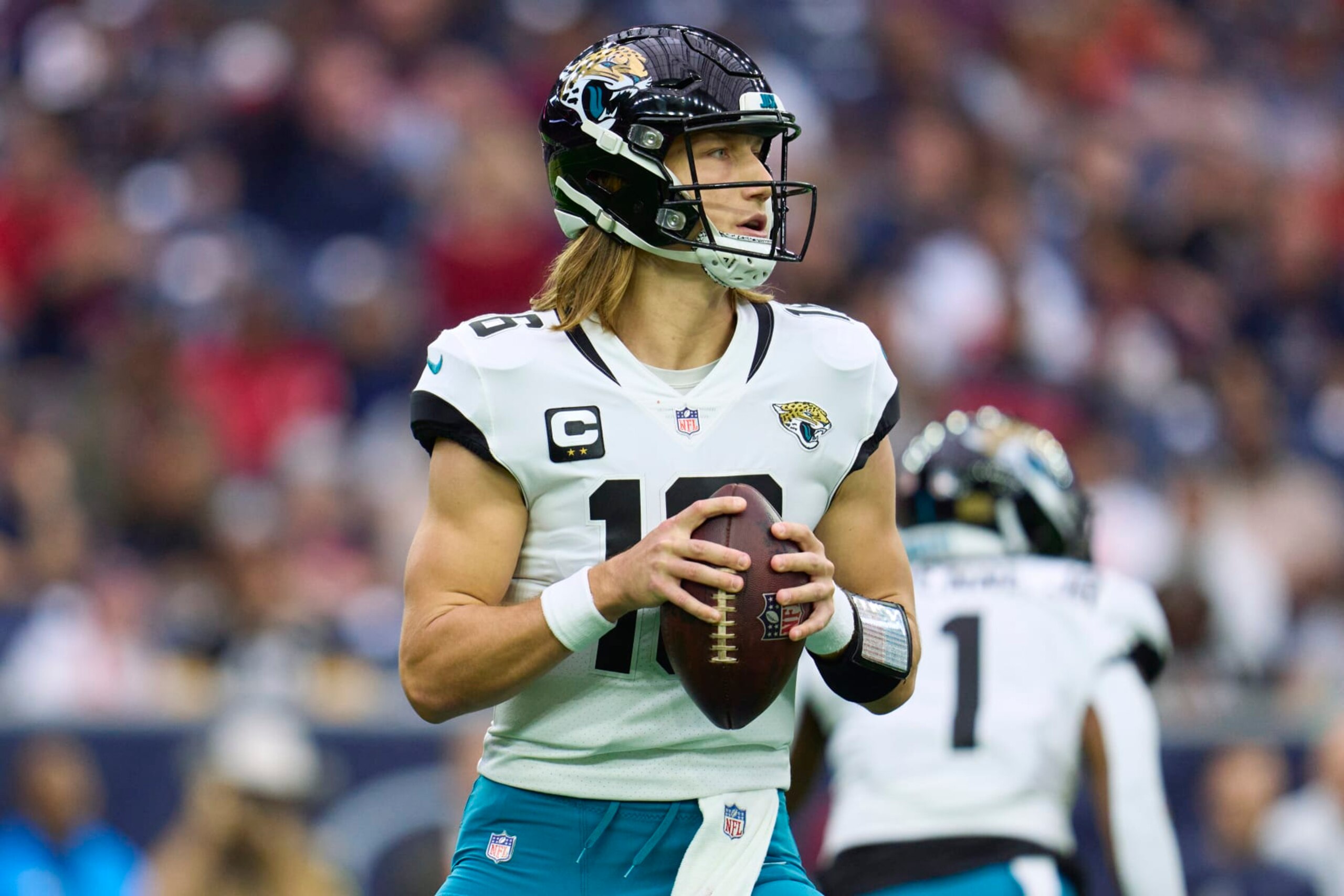 HOUSTON, TX - JANUARY 01: Trevor Lawrence #16 of the Jacksonville Jaguars drops back to pass against the Houston Texans during the first half at NRG Stadium on January 1, 2023 in Houston, Texas. (Photo by Cooper Neill/Getty Images)