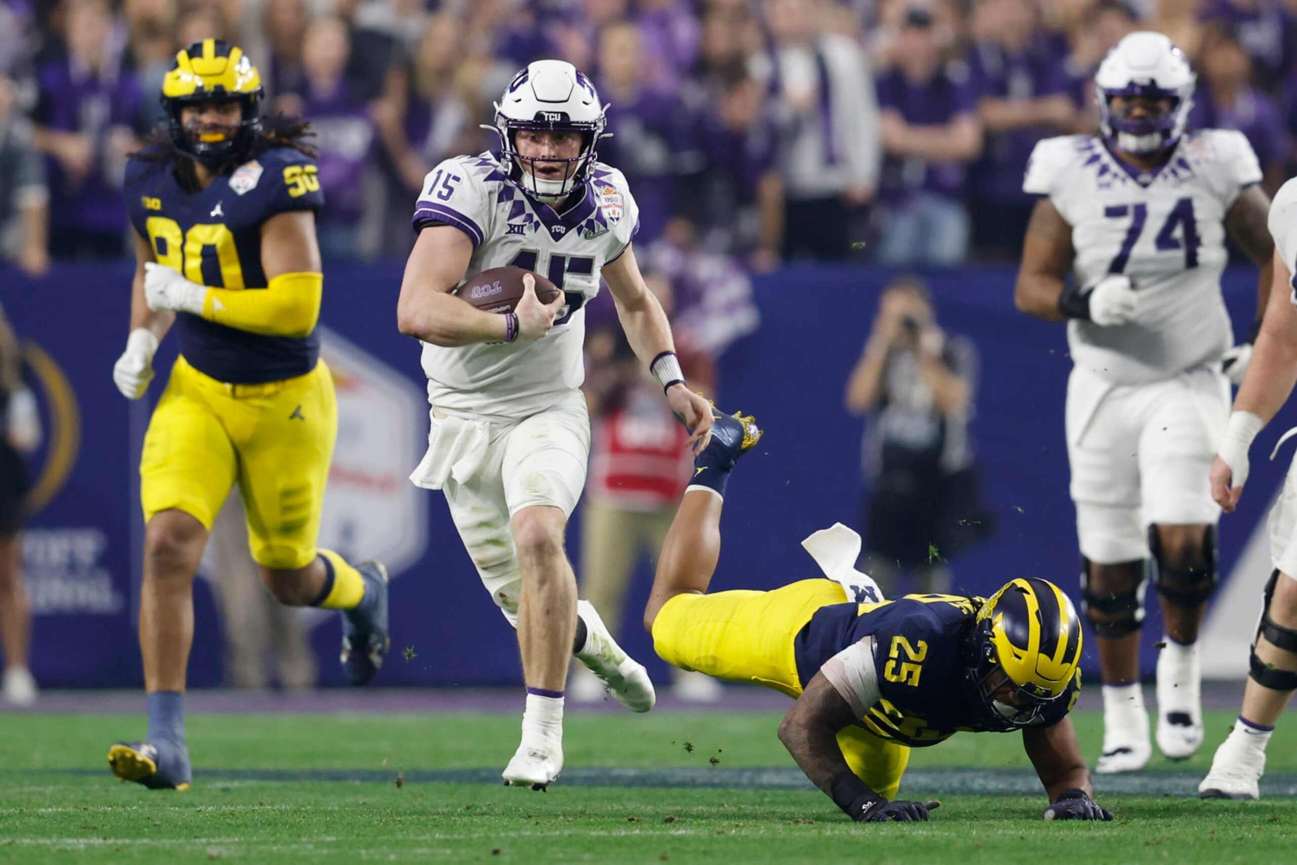 GLENDALE, ARIZONA - DECEMBER 31: Max Duggan #15 of the TCU Horned Frogs rushes during the third quarter against the Michigan Wolverines in the Vrbo Fiesta Bowl at State Farm Stadium on December 31, 2022 in Glendale, Arizona. (Photo by Chris Coduto/Getty Images)