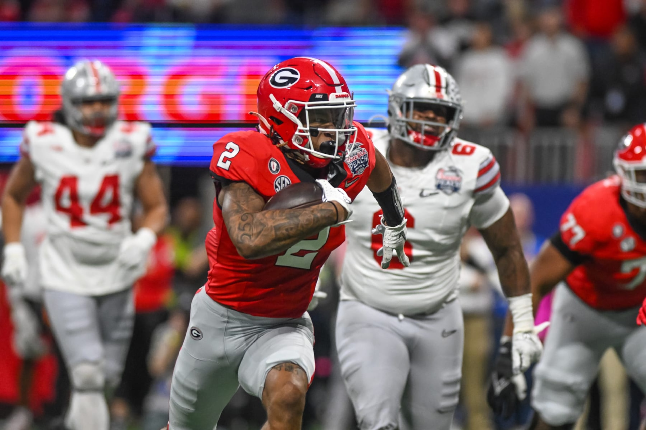 ATLANTA, GA - DECEMBER 31: Georgia Bulldogs running back Kendall Milton (2) scores a touchdown during the Chick-fil-A Peach Bowl College Football Playoff Semifinal game between the Ohio State Buckeyes and the Georgia Bulldogs on December 31, 2022, at Mercedes-Benz Stadium in Atlanta, Georgia.  (Photo by John Adams/Icon Sportswire via Getty Images)