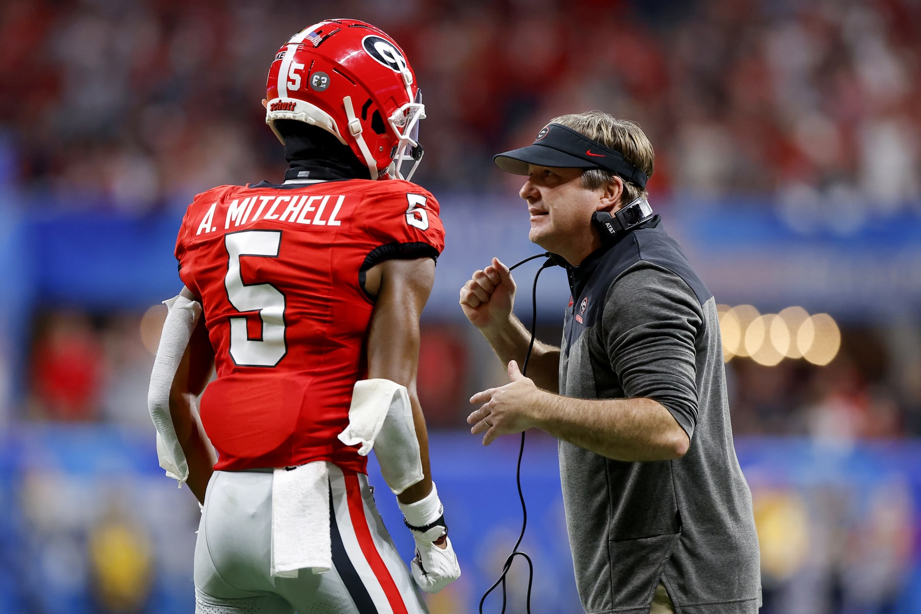 ATLANTA, GEORGIA - DECEMBER 31: Head coach Kirby Smart talks with Adonai Mitchell #5 of the Georgia Bulldogs during the fourth quarter against the Ohio State Buckeyes in the Chick-fil-A Peach Bowl at Mercedes-Benz Stadium on December 31, 2022 in Atlanta, Georgia. (Photo by Todd Kirkland/Getty Images)