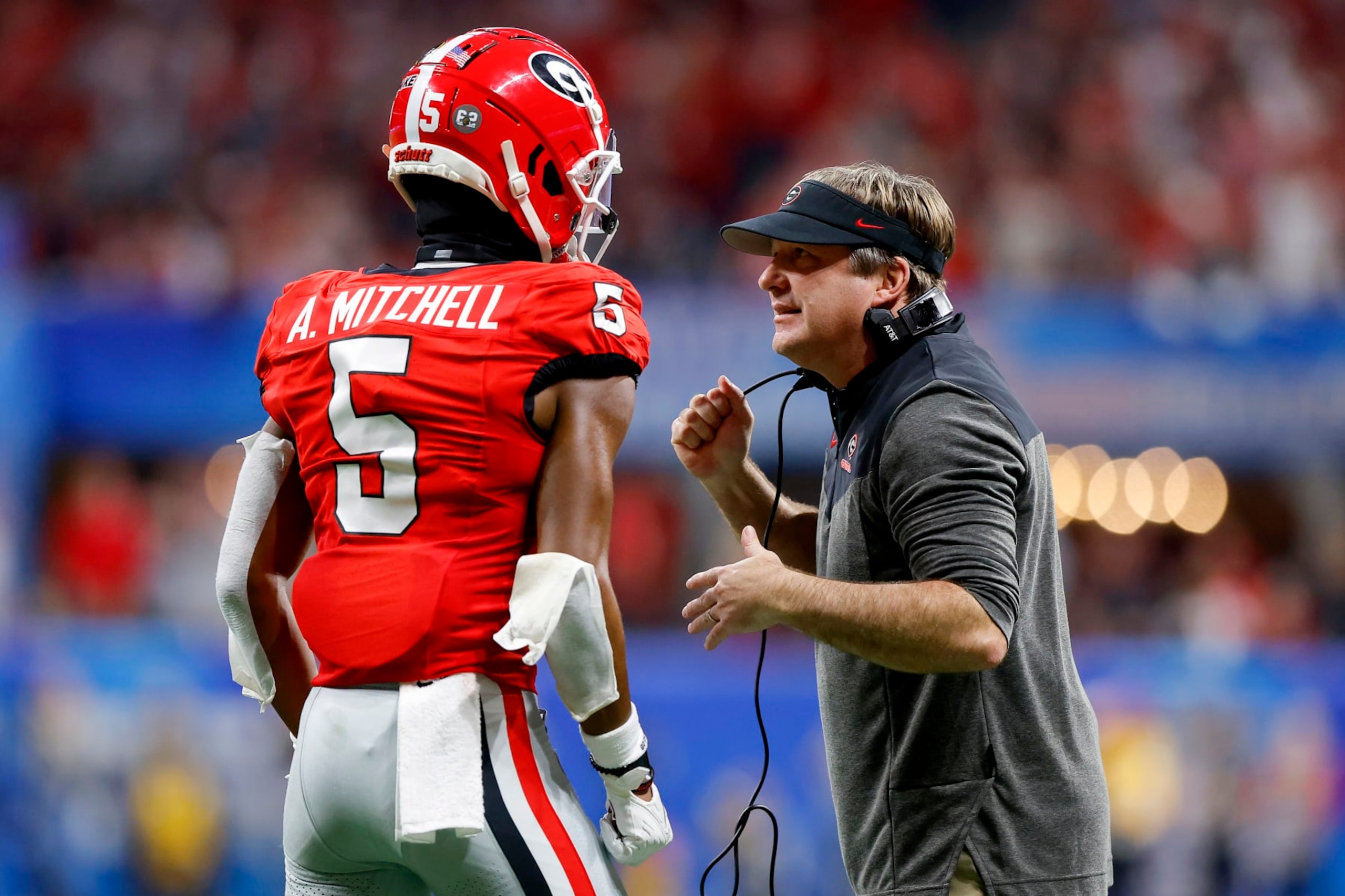 ATLANTA, GEORGIA - DECEMBER 31: Head coach Kirby Smart talks with Adonai Mitchell #5 of the Georgia Bulldogs during the fourth quarter against the Ohio State Buckeyes in the Chick-fil-A Peach Bowl at Mercedes-Benz Stadium on December 31, 2022 in Atlanta, Georgia. (Photo by Todd Kirkland/Getty Images)