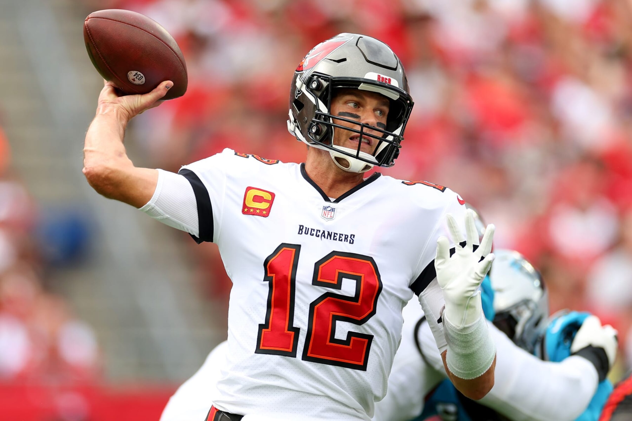 TAMPA, FLORIDA - JANUARY 01: Tom Brady #12 of the Tampa Bay Buccaneers throws a pass against the Carolina Panthers during the first half of the game at NRG Stadium on January 01, 2023 in Houston, Texas. (Photo by Mike Ehrmann/Getty Images)