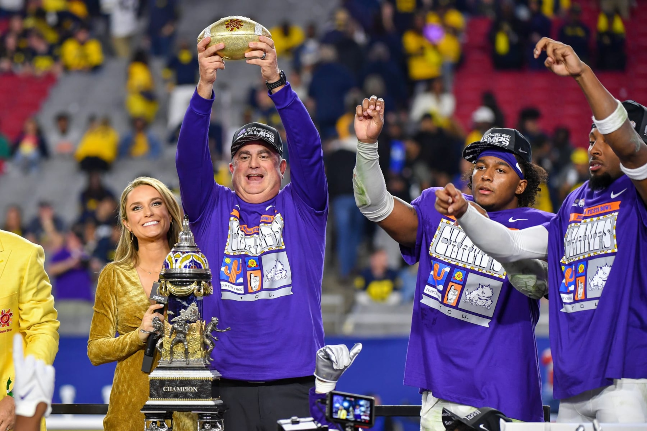 GLENDALE, ARIZONA - DECEMBER 31: Head Football Coach Sonny Dykes, Dee Winters #13, and Quinton Johnston #1 of the TCU Horned Frogs celebrate with the trophy after winning the Vrbo Fiesta Bowl college football playoff semifinal game against the Michigan Wolverines at State Farm Stadium on December 31, 2022 in Glendale, Arizona. The TCU Horned Frogs won the game 51-45 over the Michigan Wolverines (Photo by Aaron J. Thornton/Getty Images)
