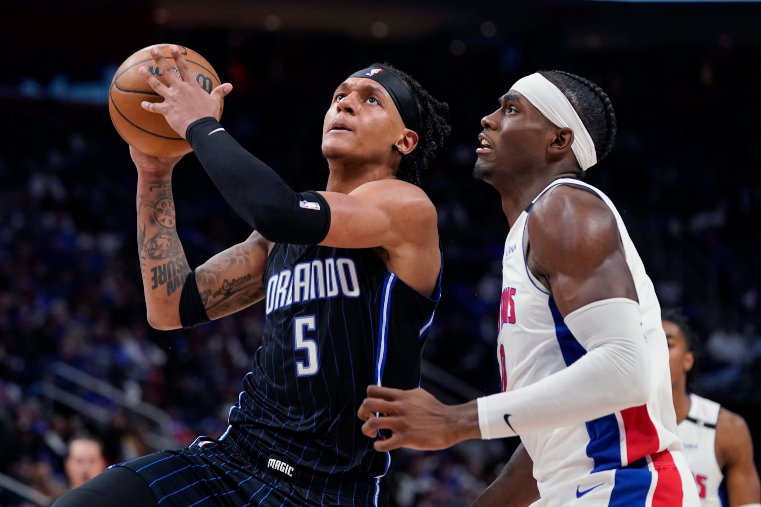 Orlando Magic forward Paolo Banchero (5) is defended by Detroit Pistons center Jalen Duren during the second half of an NBA basketball game, Wednesday, Oct. 19, 2022, in Detroit. (AP Photo/Carlos Osorio) Orlando Magic forward Paolo Banchero (5) is defended by Detroit Pistons center Jalen Duren during the second half of an NBA basketball game, Wednesday, Oct. 19, 2022, in Detroit. (AP Photo/Carlos Osorio)