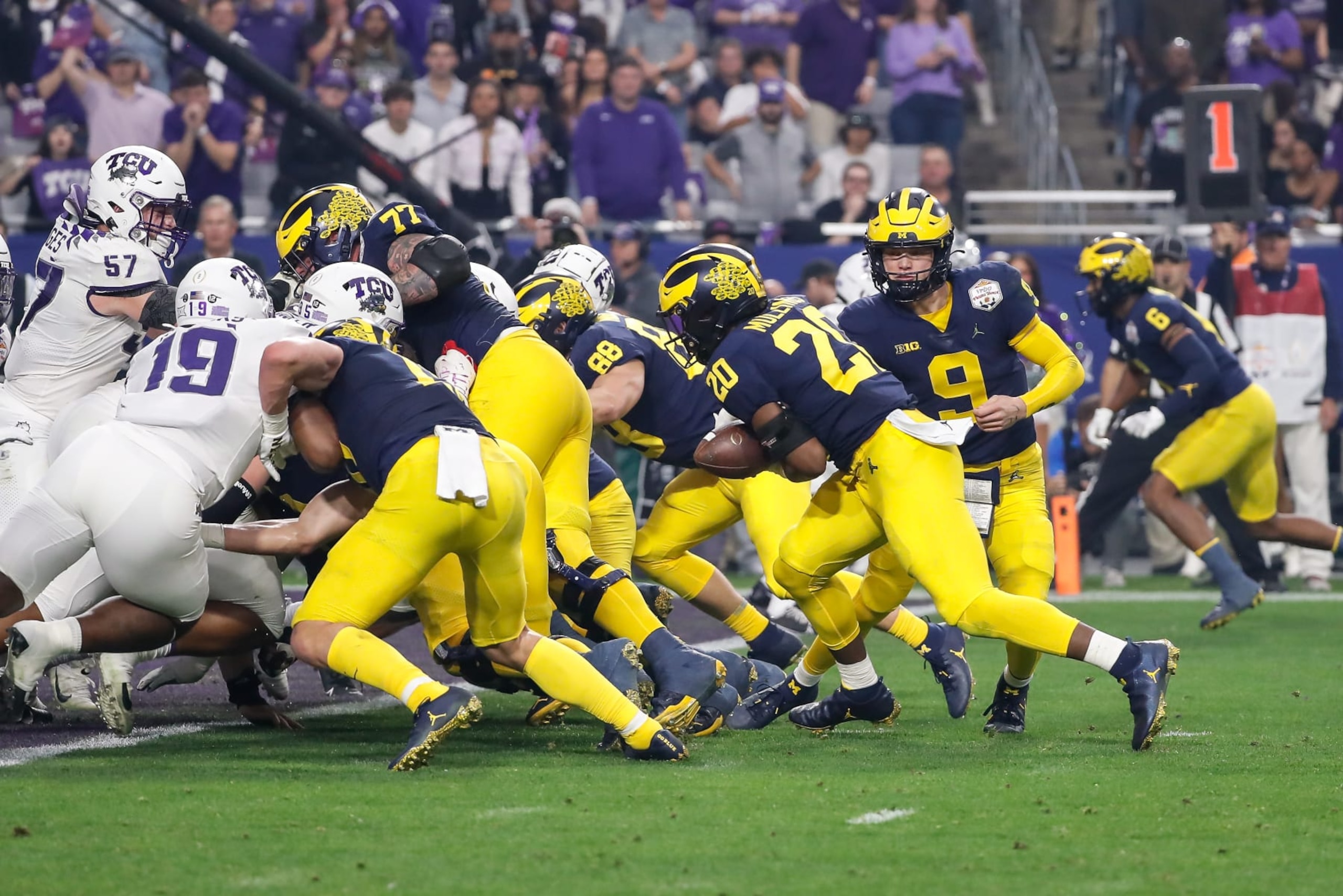 GLENDALE, AZ - DECEMBER 31:  Michigan Wolverines linebacker Kalel Mullings (20) fumbles the ball during the VRBO Fiesta Bowl college football national championship semifinal game between the Michigan Wolverines and the TCU Horned Frogs on December 31, 2022 at State Farm Stadium in Glendale, Arizona. (Photo by Kevin Abele/Icon Sportswire via Getty Images)