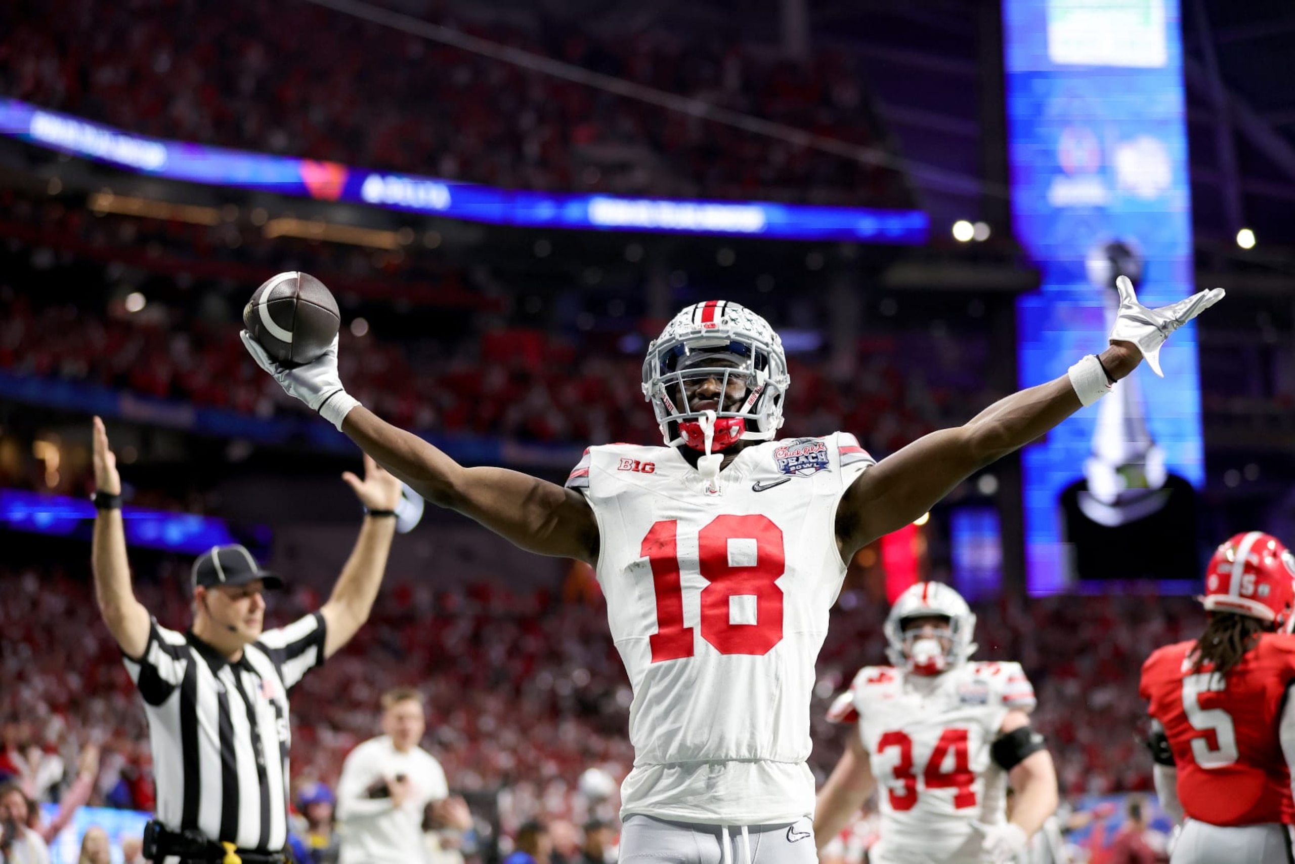 ATLANTA, GEORGIA - DECEMBER 31: Marvin Harrison Jr. #18 of the Ohio State Buckeyes celebrates after a touchdown during the second quarter in the Chick-fil-A Peach Bowl at Mercedes-Benz Stadium on December 31, 2022 in Atlanta, Georgia. (Photo by Carmen Mandato/Getty Images) ATLANTA, GEORGIA - DECEMBER 31: Marvin Harrison Jr. #18 of the Ohio State Buckeyes celebrates after a touchdown during the second quarter in the Chick-fil-A Peach Bowl at Mercedes-Benz Stadium on December 31, 2022 in Atlanta, Georgia. (Photo by Carmen Mandato/Getty Images)