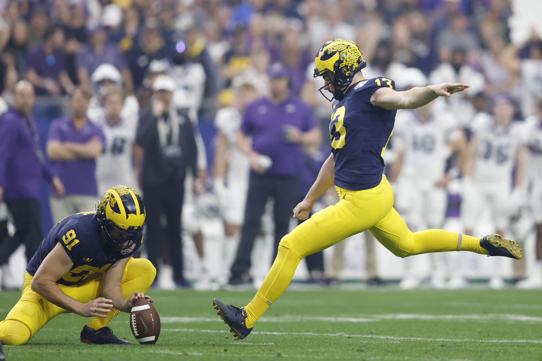 GLENDALE, ARIZONA - DECEMBER 31: Jake Moody #13 of the Michigan Wolverines kicks a field goal during the second quarter against the TCU Horned Frogs in the Vrbo Fiesta Bowl at State Farm Stadium on December 31, 2022 in Glendale, Arizona. (Photo by Chris Coduto/Getty Images)