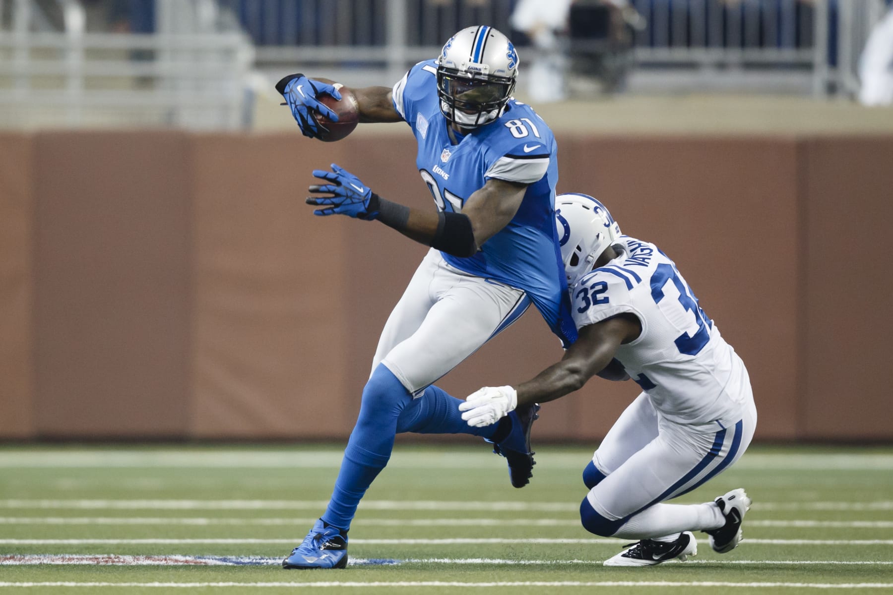 Detroit Lions wide receiver Calvin Johnson (81) runs the ball as Indianapolis Colts cornerback Cassius Vaughn (32) defends in the first half of an NFL football game at Ford Field in Detroit, Sunday, Dec. 2, 2012. (AP Photo/Rick Osentoski)