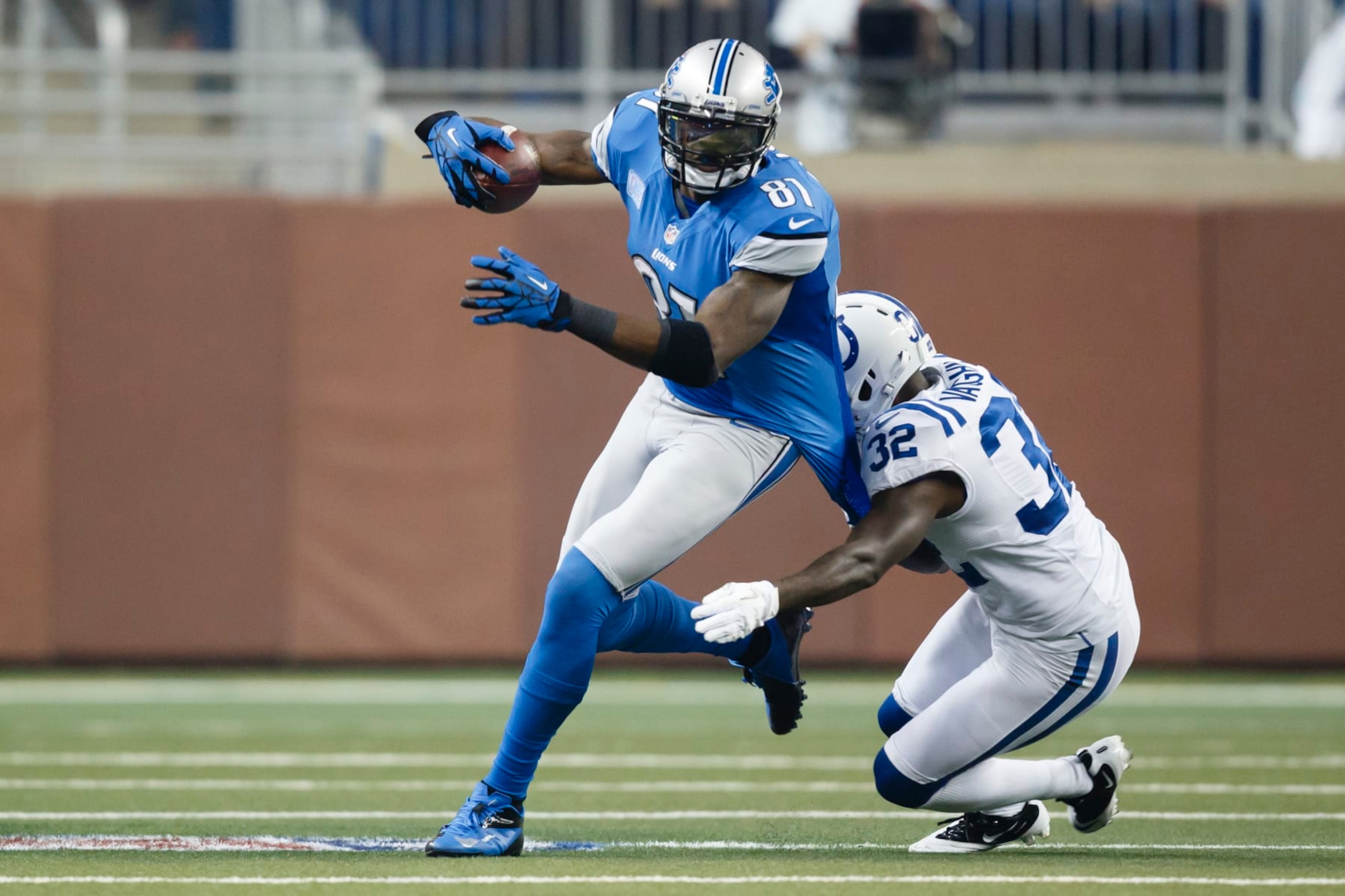 Detroit Lions wide receiver Calvin Johnson (81) runs the ball as Indianapolis Colts cornerback Cassius Vaughn (32) defends in the first half of an NFL football game at Ford Field in Detroit, Sunday, Dec. 2, 2012. (AP Photo/Rick Osentoski)
