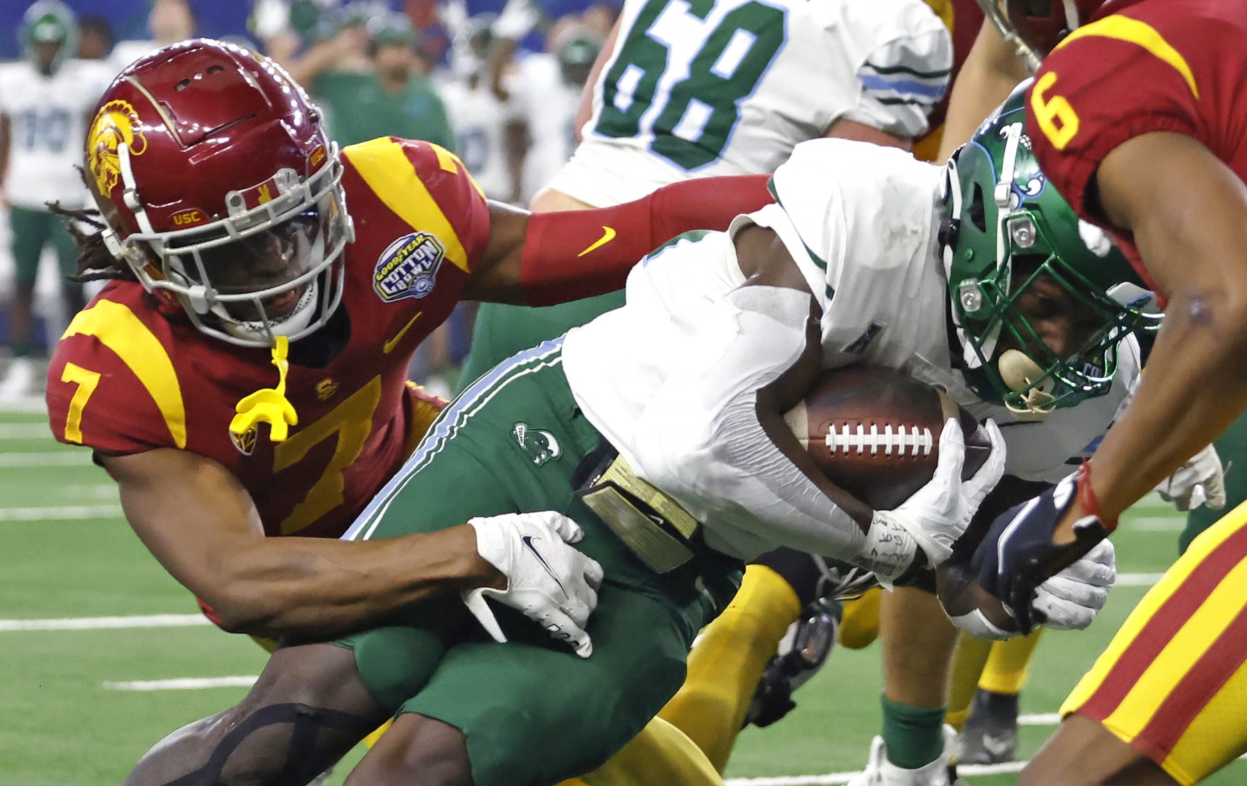 ARLINGTON, TX - JANUARY 2: Tyjae Spears #22 of the Tulane Green Wave runs the ball in for a touchdown as Calen Bullock #7 of the USC Trojans tries to make the stop in the first half of the Goodyear Cotton Bowl Classic on January 2, 2023 at AT&T Stadium in Arlington, Texas. (Photo by Ron Jenkins/Getty Images)