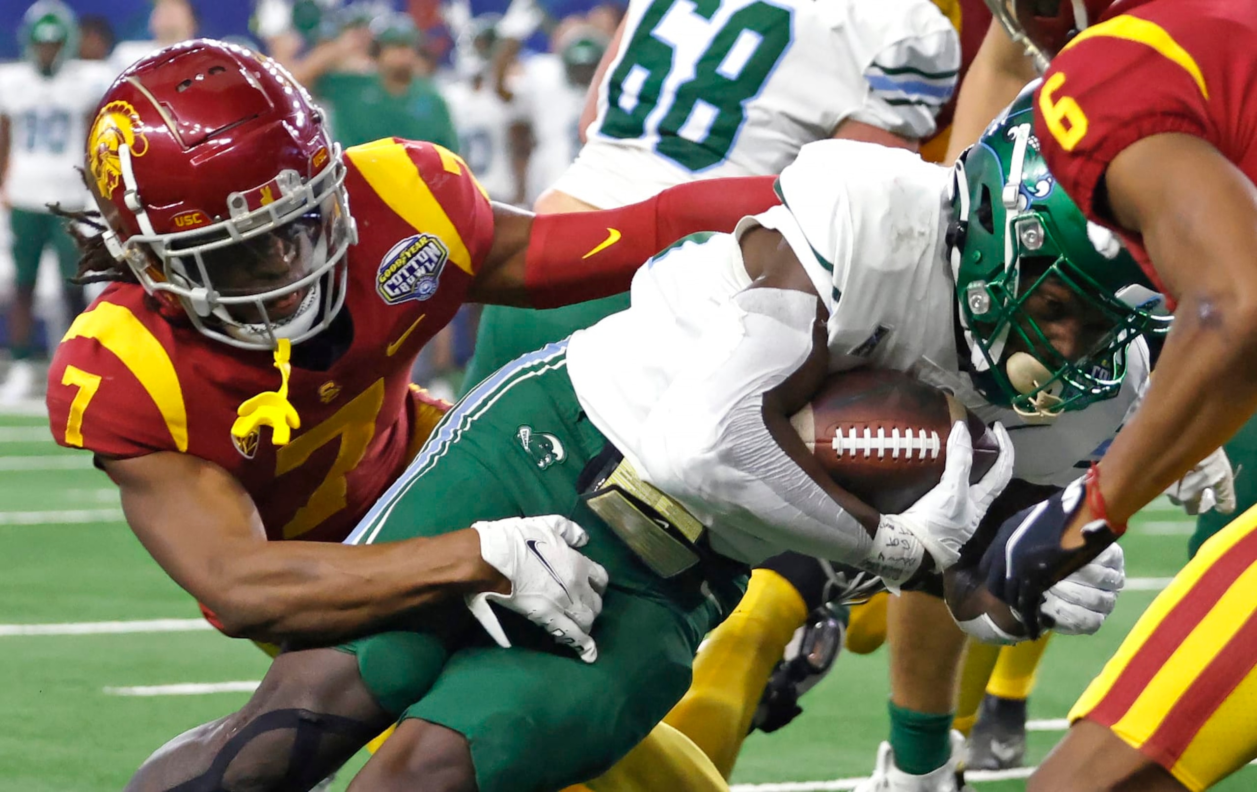 ARLINGTON, TX - JANUARY 2: Tyjae Spears #22 of the Tulane Green Wave runs the ball in for a touchdown as Calen Bullock #7 of the USC Trojans tries to make the stop in the first half of the Goodyear Cotton Bowl Classic on January 2, 2023 at AT&T Stadium in Arlington, Texas. (Photo by Ron Jenkins/Getty Images)