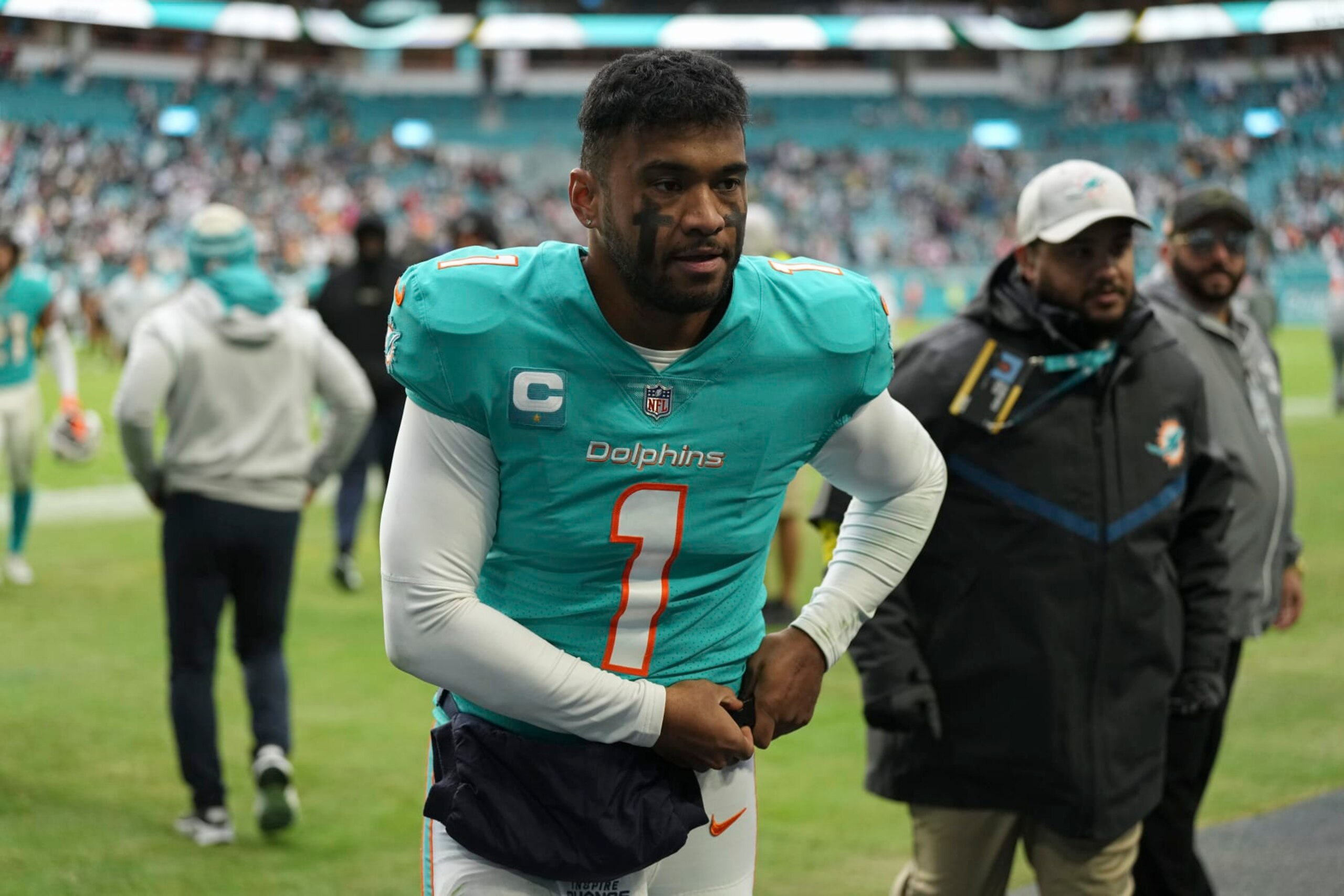 Miami Dolphins quarterback Tua Tagovailoa (1) walks off the field after an NFL football game against the Green Bay Packers, Sunday, Dec. 25, 2022, in Miami Gardens, Fla. (AP Photo/Jim Rassol)