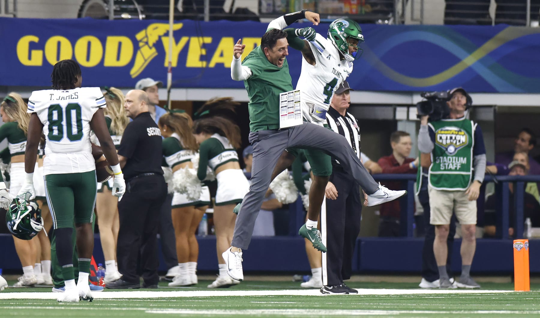 ARLINGTON, TX - JANUARY 2: JhaQuan Jackson #4 of the Tulane Green Wave celebrates with wide receivers coach John McMenamin after scoring a touchdown against the USC Trojans in the first half of the Goodyear Cotton Bowl Classic on January 2, 2023 at AT&T Stadium in Arlington, Texas. (Photo by Ron Jenkins/Getty Images)