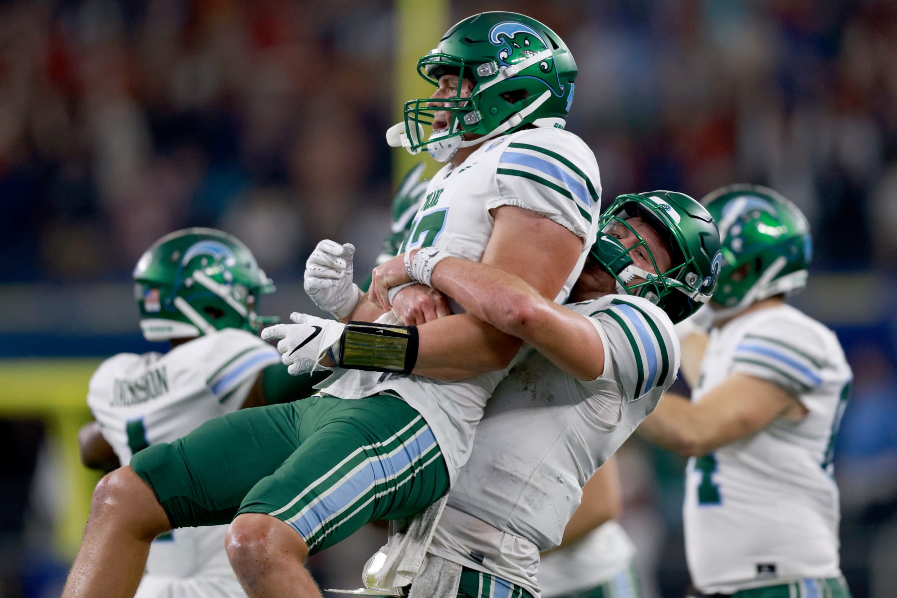 ARLINGTON, TEXAS - JANUARY 02: Alex Bauman #87 of the Tulane Green Wave celebrates with Michael Pratt #7 of the Tulane Green Wave after scoring a touchdown against USC Trojans in the fourth quarter the Goodyear Cotton Bowl Classic on January 02, 2023 at AT&T Stadium in Arlington, Texas. (Photo by Tom Pennington/Getty Images)