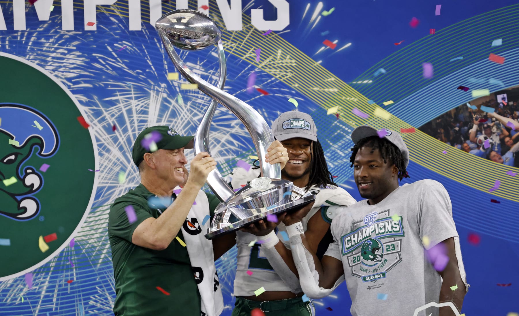 ARLINGTON, TX - JANUARY 2: Head coach Willie Fritz of the Tulane Green Wave celebrates with players Dorian Williams #2 of the Tulane Green Wave and Tyjae Spears #22 following the teams 46-45 win against the USC Trojans in the Goodyear Cotton Bowl Classic on January 2, 2023 at AT&T Stadium in Arlington, Texas. (Photo by Ron Jenkins/Getty Images)