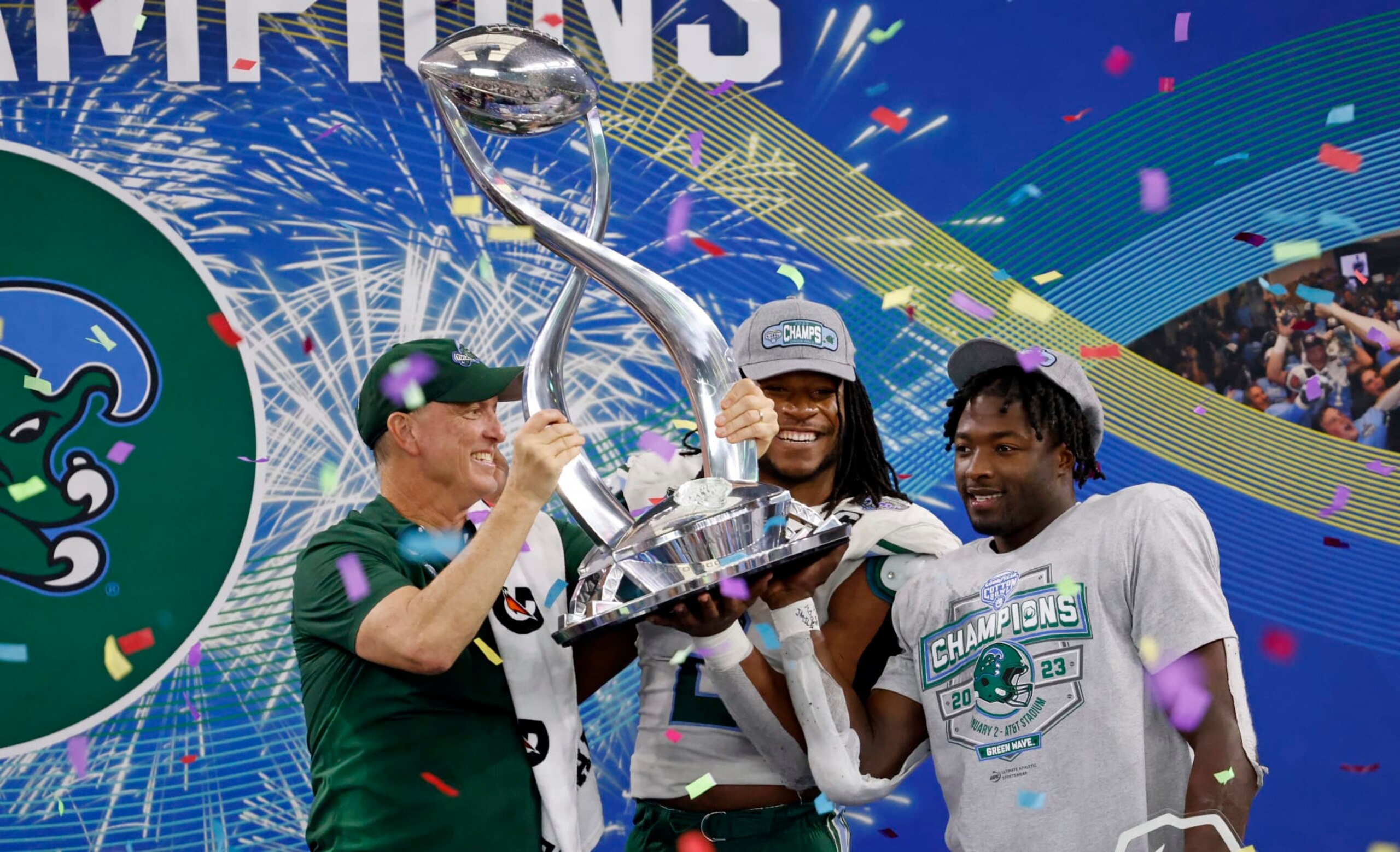 ARLINGTON, TX - JANUARY 2: Head coach Willie Fritz of the Tulane Green Wave celebrates with players Dorian Williams #2 of the Tulane Green Wave and Tyjae Spears #22 following the teams 46-45 win against the USC Trojans in the Goodyear Cotton Bowl Classic on January 2, 2023 at AT&T Stadium in Arlington, Texas. (Photo by Ron Jenkins/Getty Images)