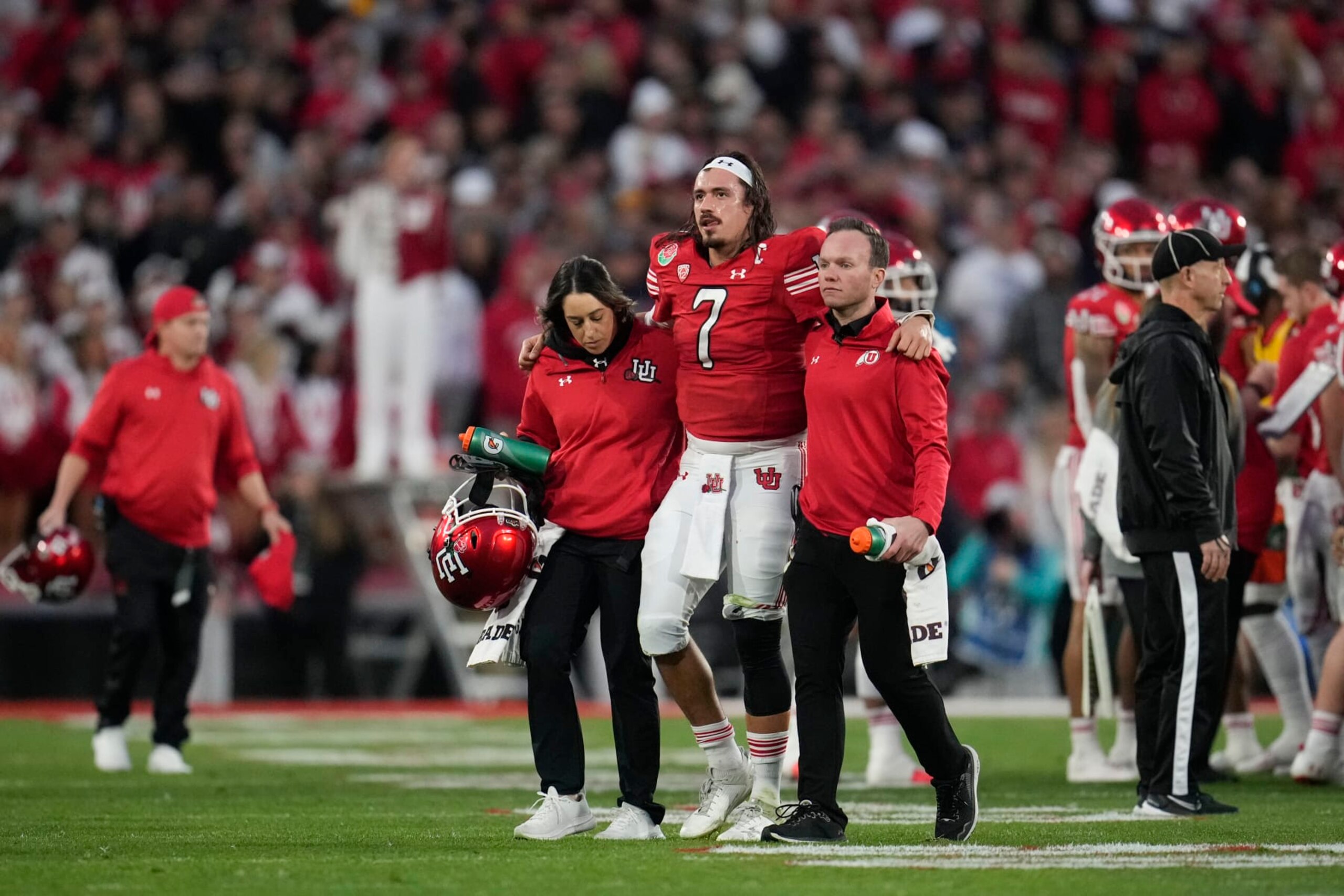 Utah quarterback Cameron Rising (7) is helped off the field during the second half in the Rose Bowl NCAA college football game against Penn State Monday, Jan. 2, 2023, in Pasadena, Calif. (AP Photo/Marcio Jose Sanchez)