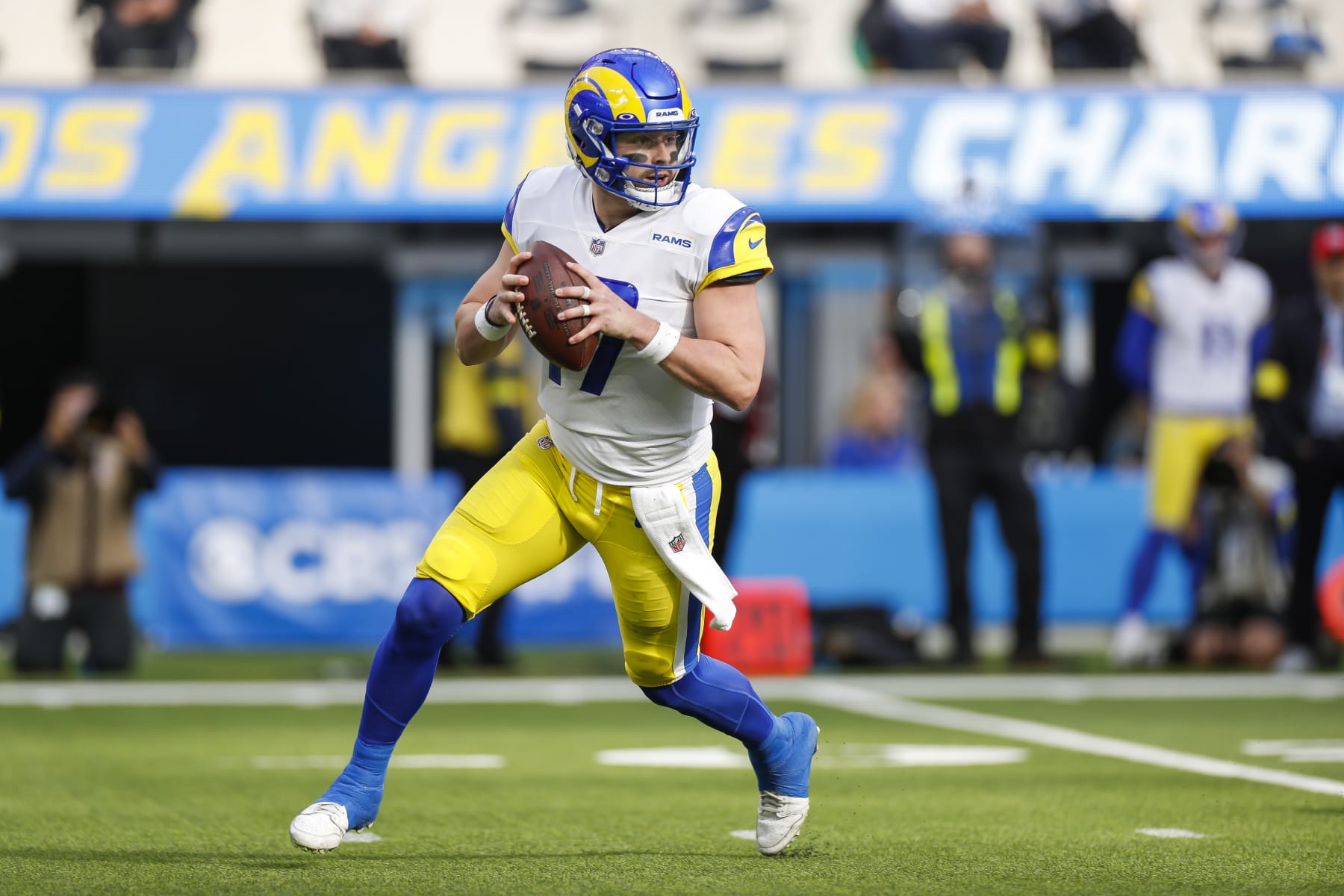 INGLEWOOD, CA - JANUARY 01: Los Angeles Rams quarterback Baker Mayfield (17) rolls out to pass during an NFL regular season game between the Los Angeles Rams and the Los Angeles Chargers on January 01, 2023, at SoFi Stadium in Inglewood, CA.(Photo by Brandon Sloter/Icon Sportswire via Getty Images)