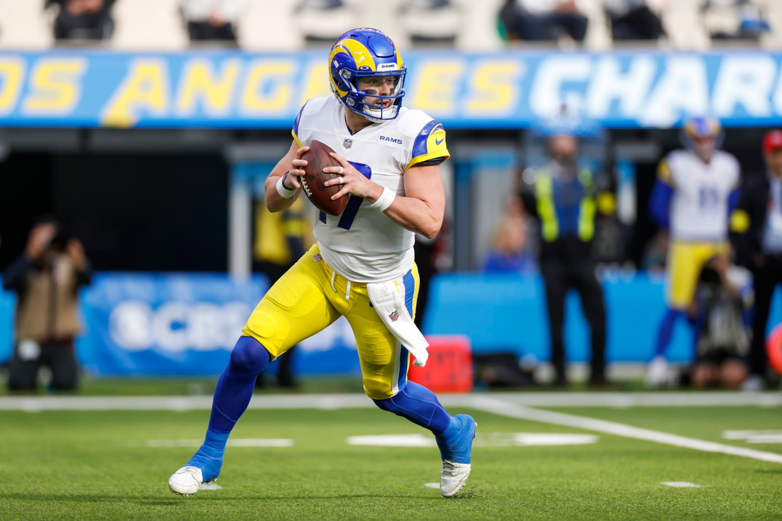 INGLEWOOD, CA - JANUARY 01: Los Angeles Rams quarterback Baker Mayfield (17) rolls out to pass during an NFL regular season game between the Los Angeles Rams and the Los Angeles Chargers on January 01, 2023, at SoFi Stadium in Inglewood, CA.(Photo by Brandon Sloter/Icon Sportswire via Getty Images)