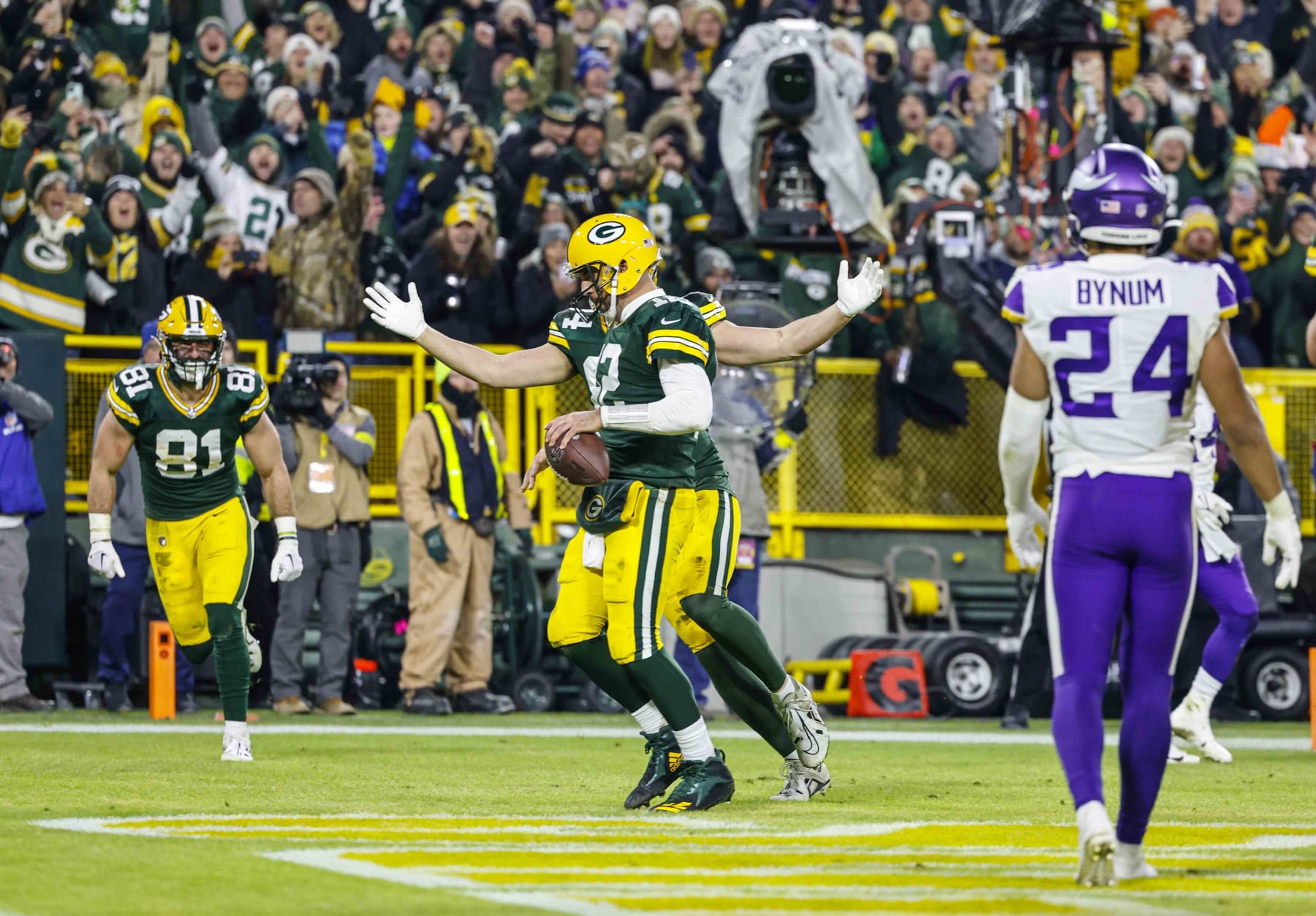 Green Bay Packers quarterback Aaron Rodgers (12) runs in for a touchdown during an NFL football game against the Minnesota Vikings Sunday, Jan. 1, 2023, in Green Bay, Wis. (AP Photo/Jeffrey Phelps)