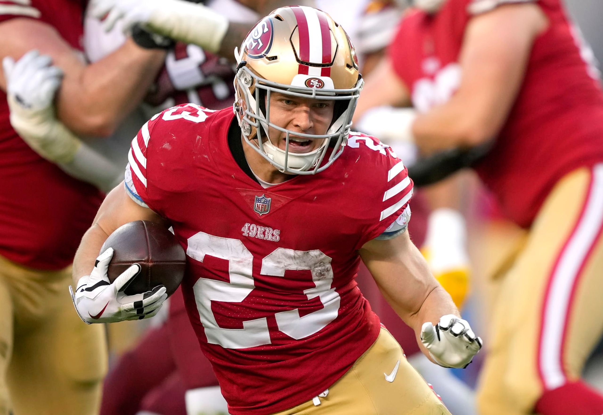 SANTA CLARA, CALIFORNIA - DECEMBER 24: Christian McCaffrey #23 of the San Francisco 49ers carries the ball against the Washington Commanders during the fourth quarter of an NFL football game at Levi's Stadium on December 24, 2022 in Santa Clara, California. (Photo by Thearon W. Henderson/Getty Images)